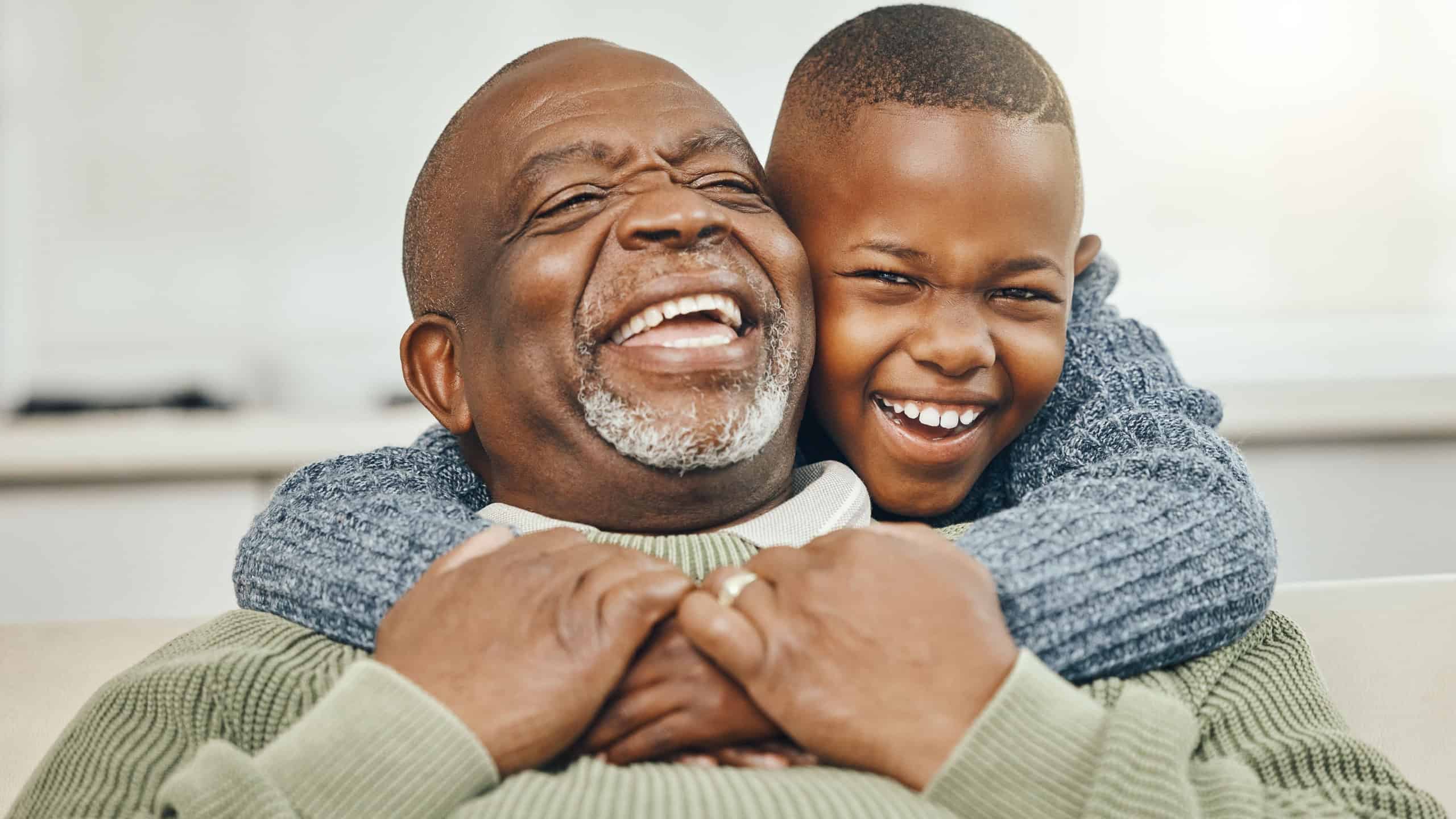 My boy, from my boy. Shot of a grandfather bonding with his young grandson on a sofa at home.