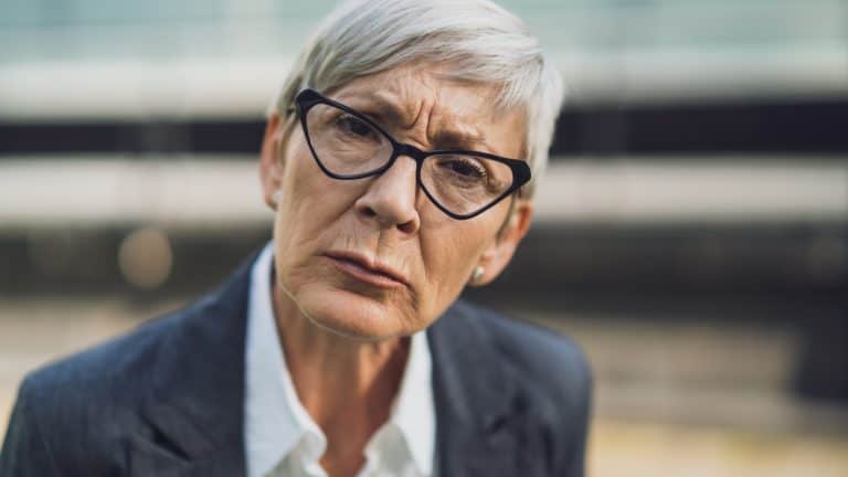 Close up portrait of senior businesswoman who is angry and worried.