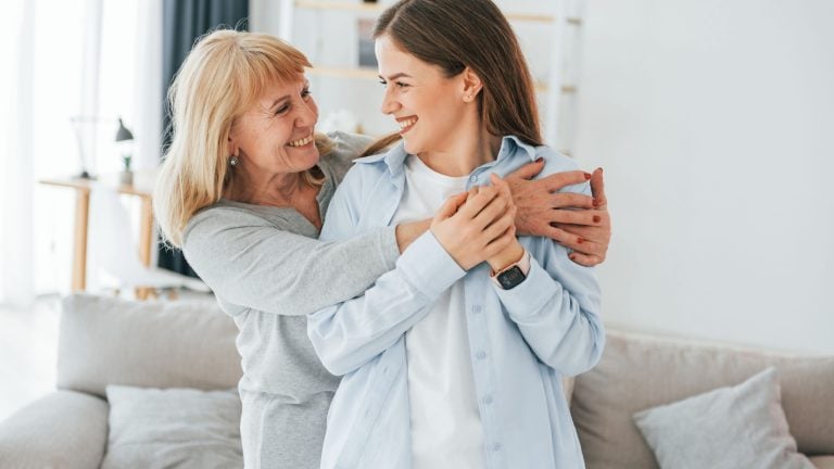 Embracing each other. Grandmother and daughter is together at home.
