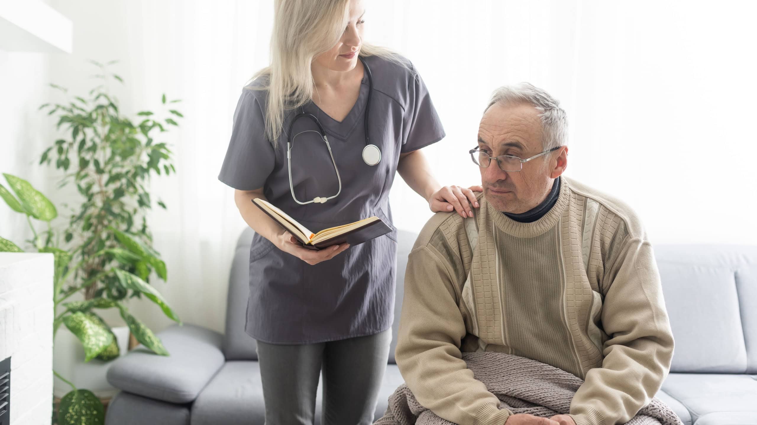 Upset older man listening to supportive speech of pleasant female doctor, head shot close up.