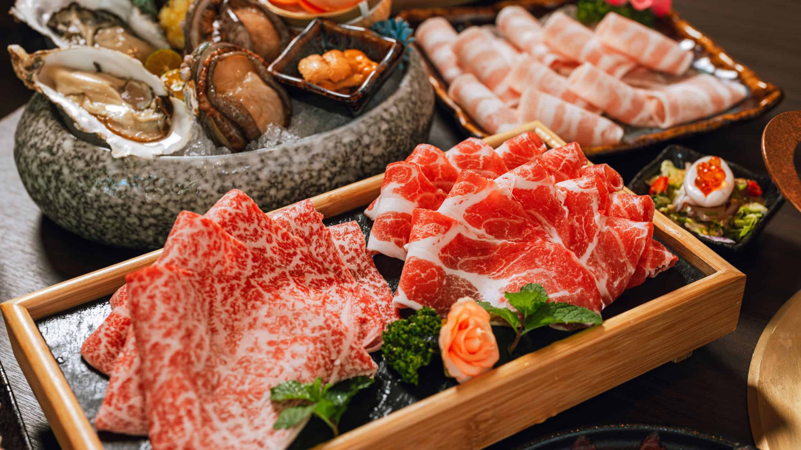 Seafood cuisine plate and beef sliced meat for hot pots. pork slices, scallops, seashells, oysters, caviar and other seafood delicacies.
