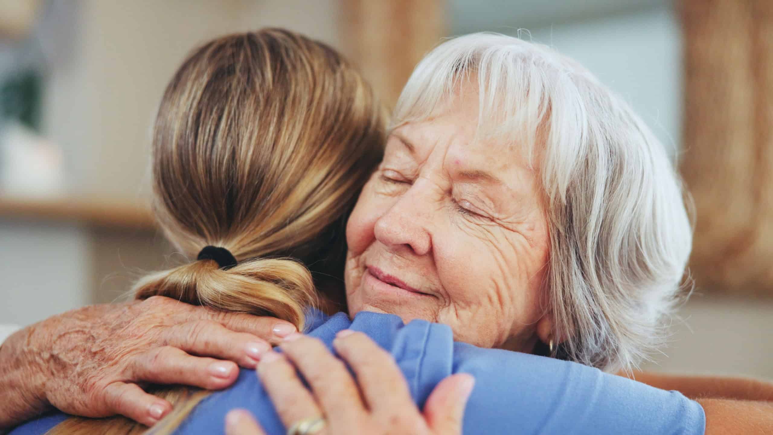 Senior woman, nurse and hug with support for love