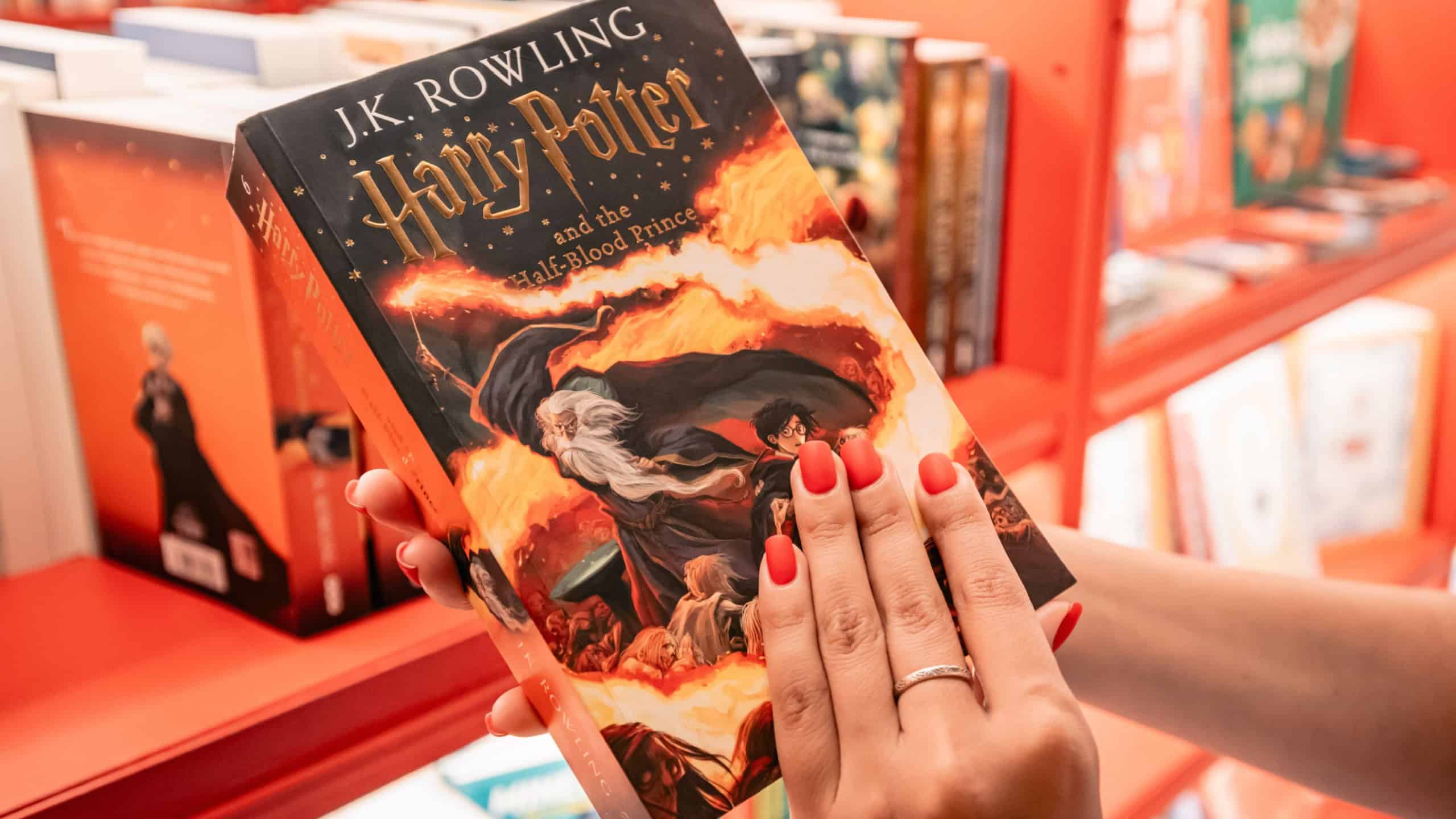 09 July 2024, Istanbul, Turkey: A fan holding the Harry Potter book Half-Blood Prince in a bookstore, browsing the pages