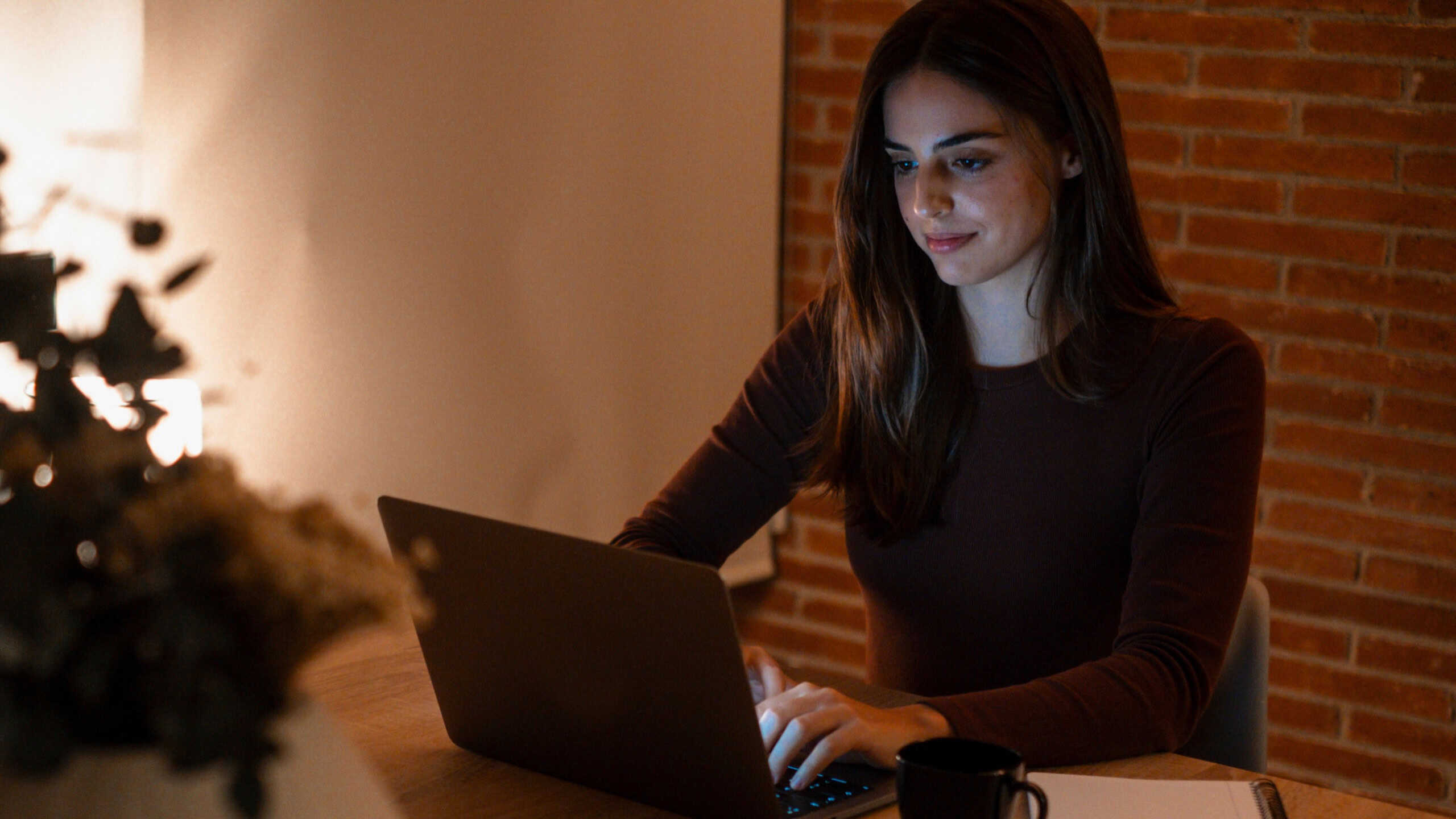 Inspired millennial woman manager writer developing project take notes of creative idea on pc. Diligent young lady intern sit up late working on laptop in office prepare document in corporate network