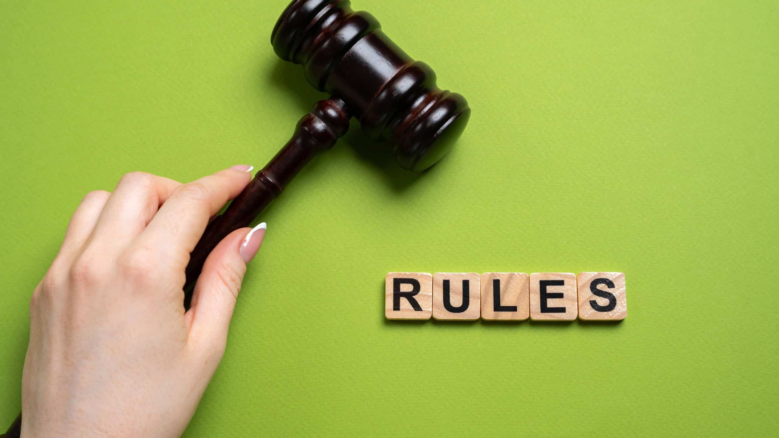 Judge's gavel and the word Rules in blocks. Law, justice, legal authority, courtroom decisions, and the importance of regulations. Court concept