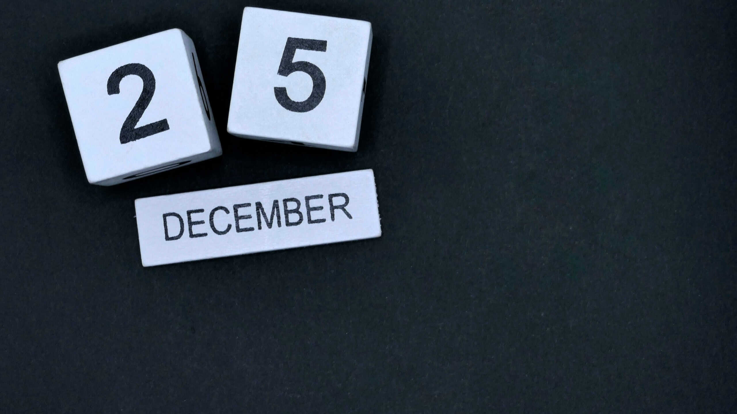 Calendar wood block December 25th Christmas Day on black background