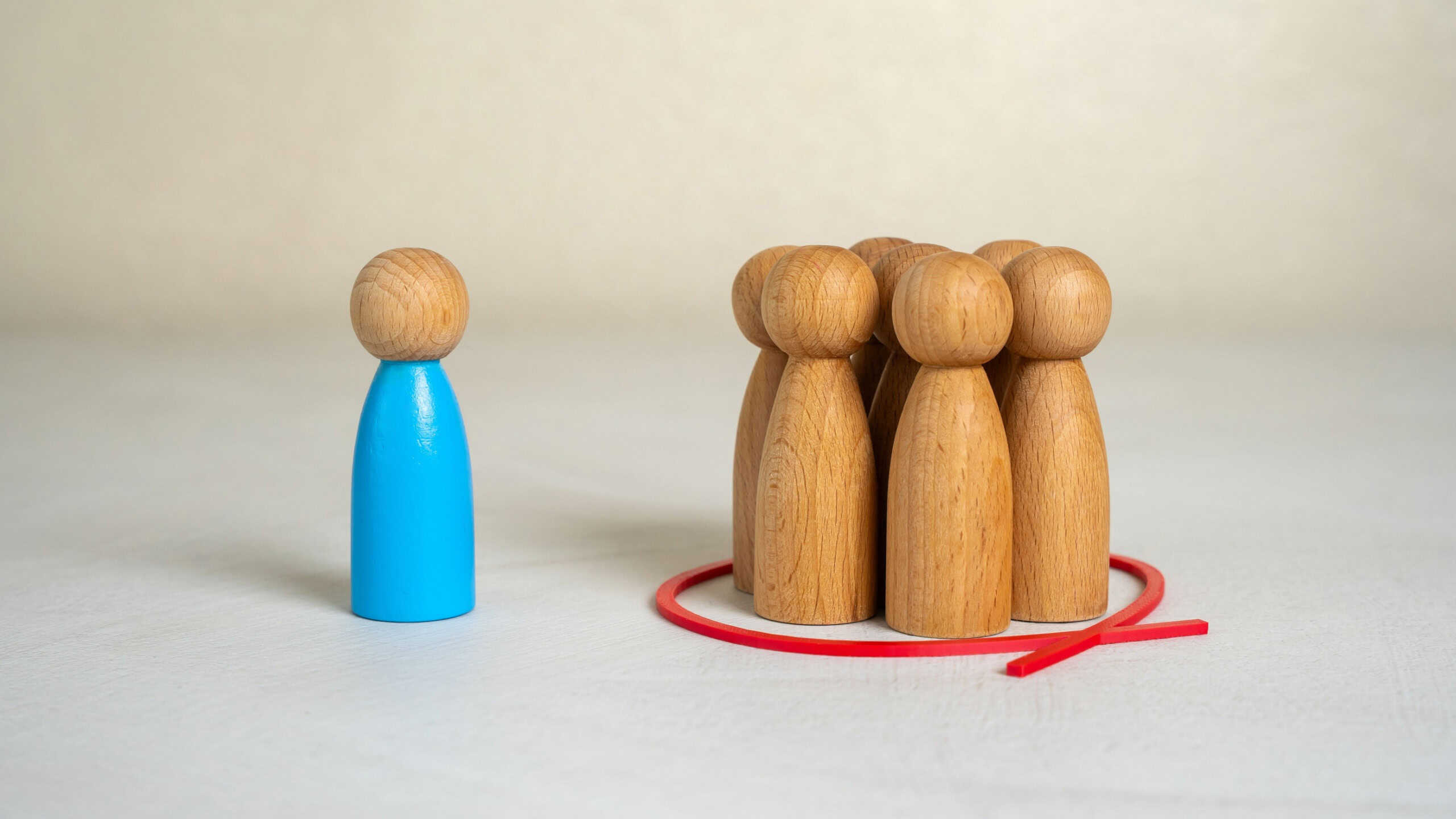 Wooden figures representing exclusion or discrimination