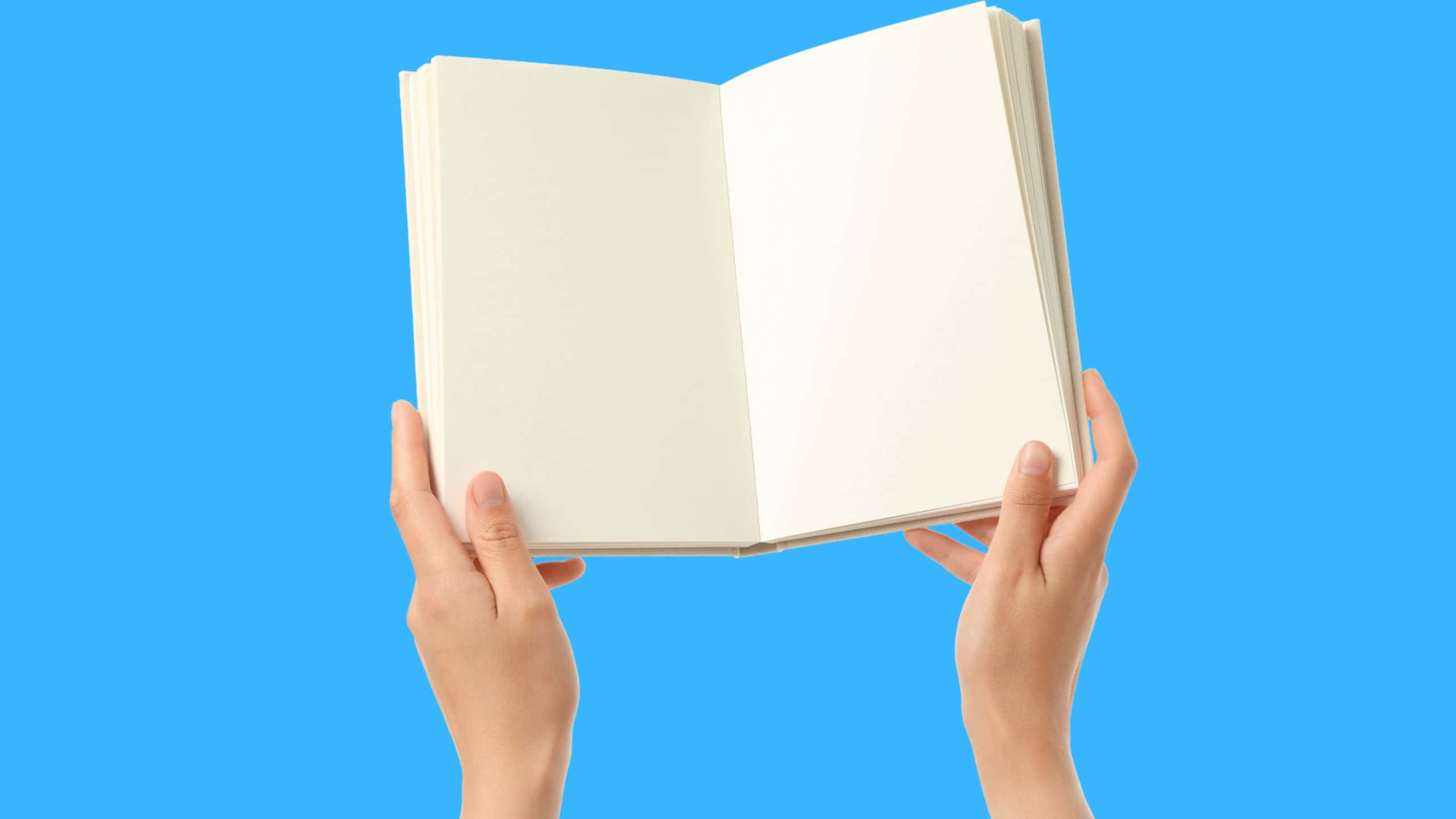 Two hands hold an open book, sparking creativity