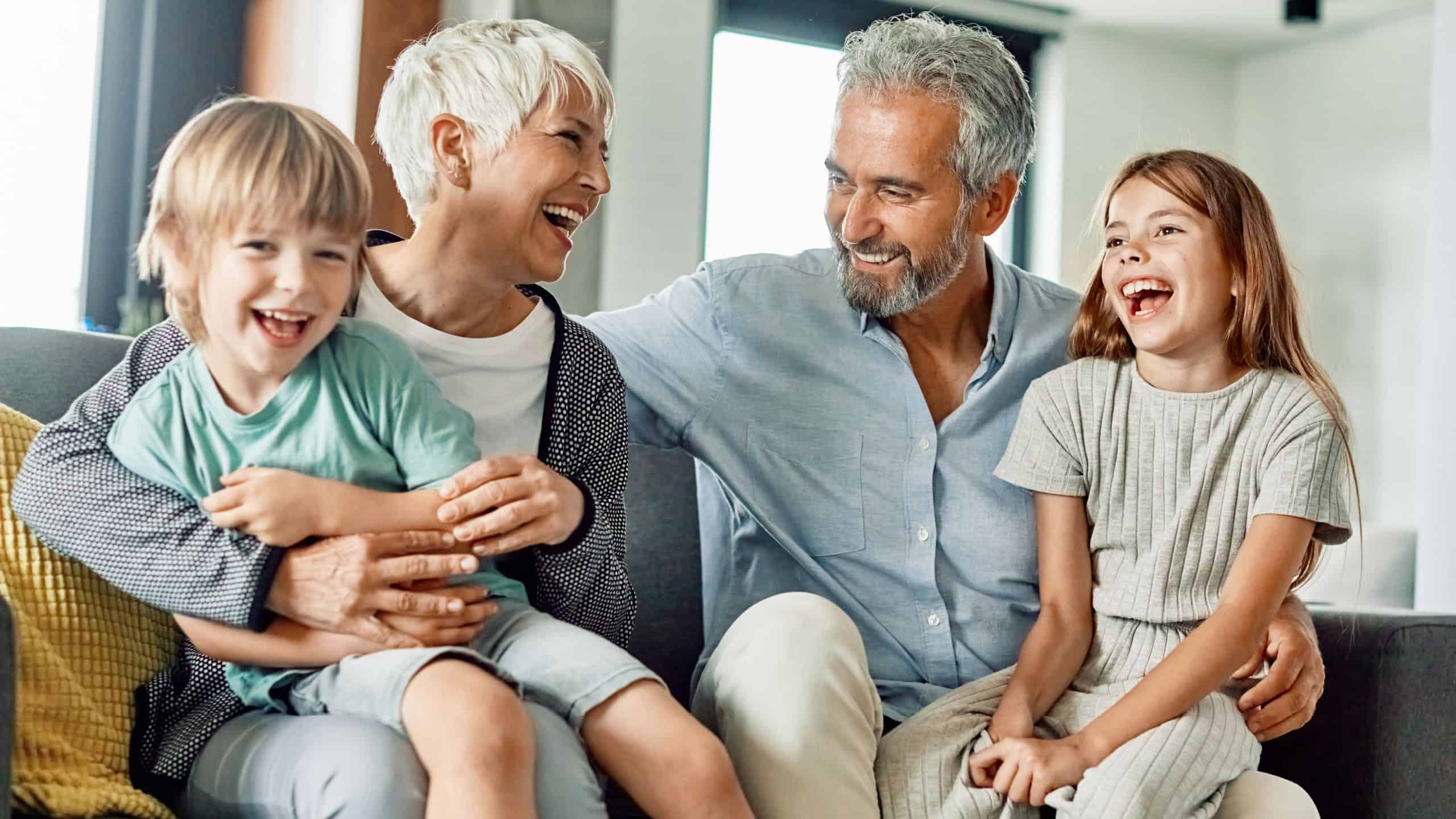 Portrait of grandparents and grandchildren having fun together at home