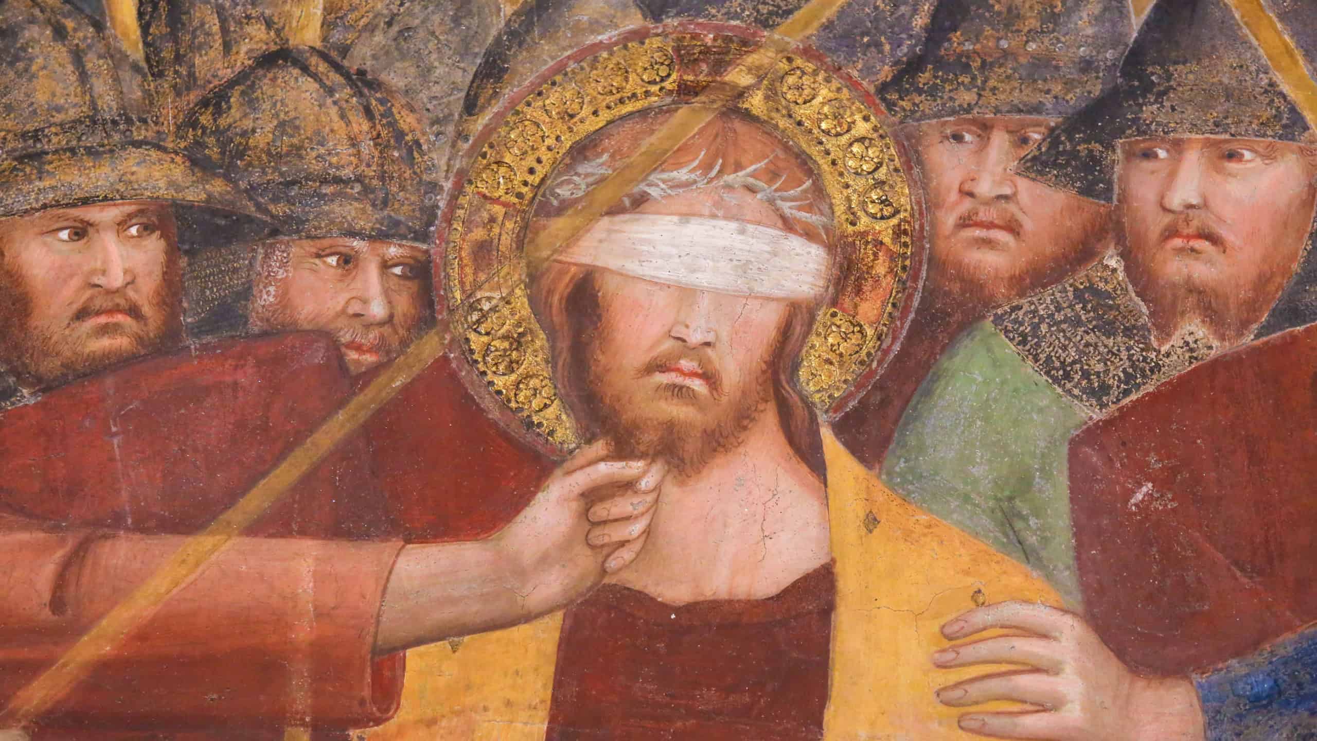 SAN GIMIGNANO, ITALY - JULY 11, 2017: Renaissance Fresco depicting Jesus, blindfolded, on Good Friday, in the Collegiata of San Gimignano, Italy.