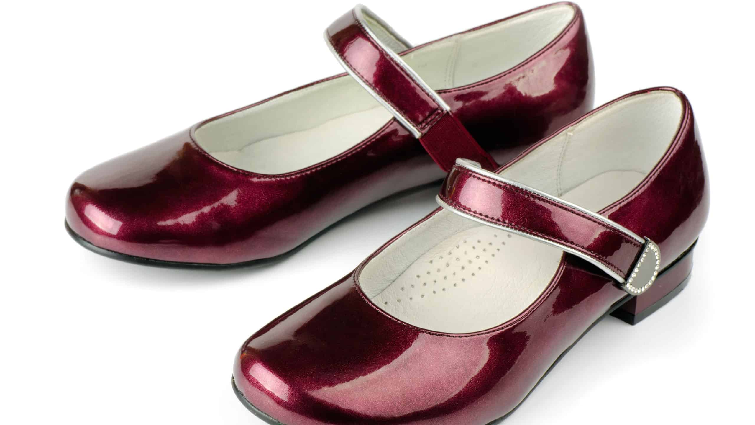 Red girls patent leather shoes isolated on white