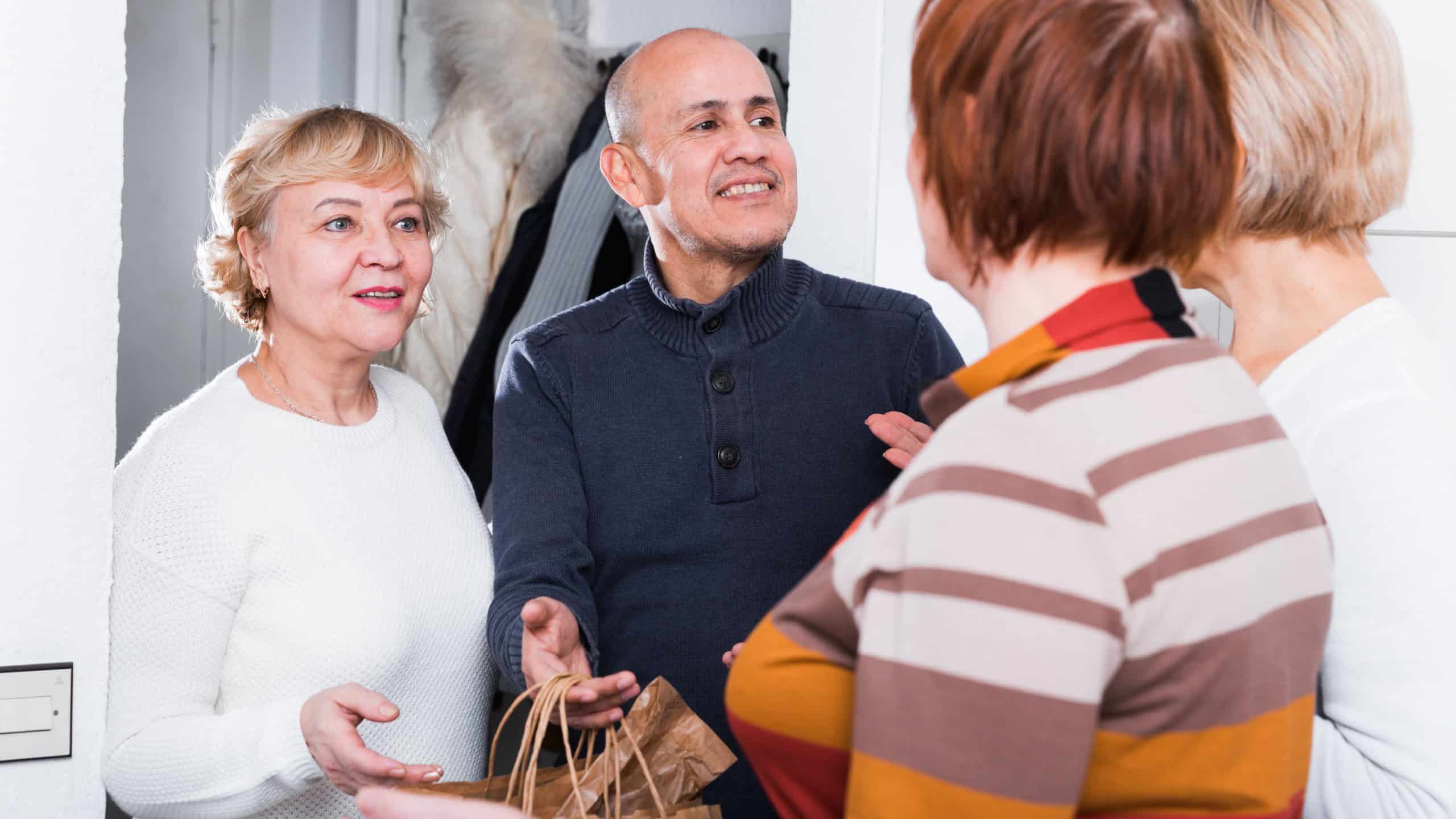 Mature friends are meeting for resting together at home.