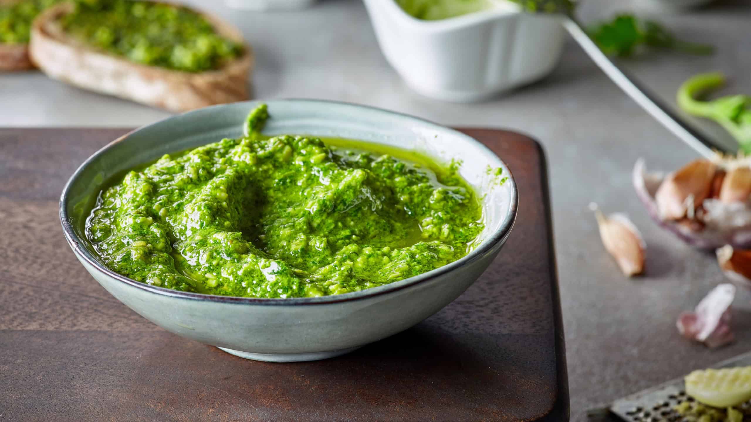 Bowl of basil pesto, selective focus