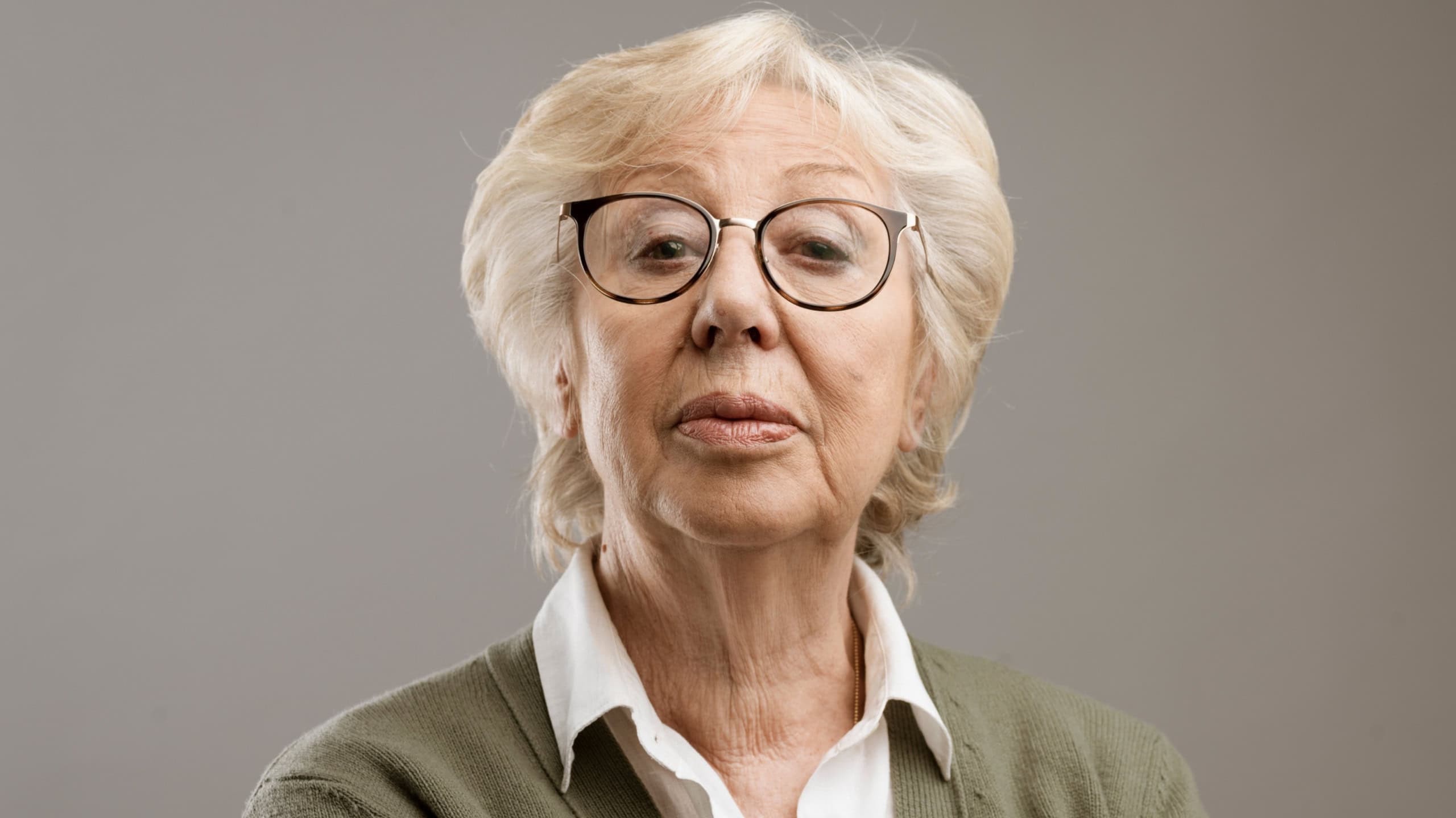 Confident senior lady looking at camera with disdain