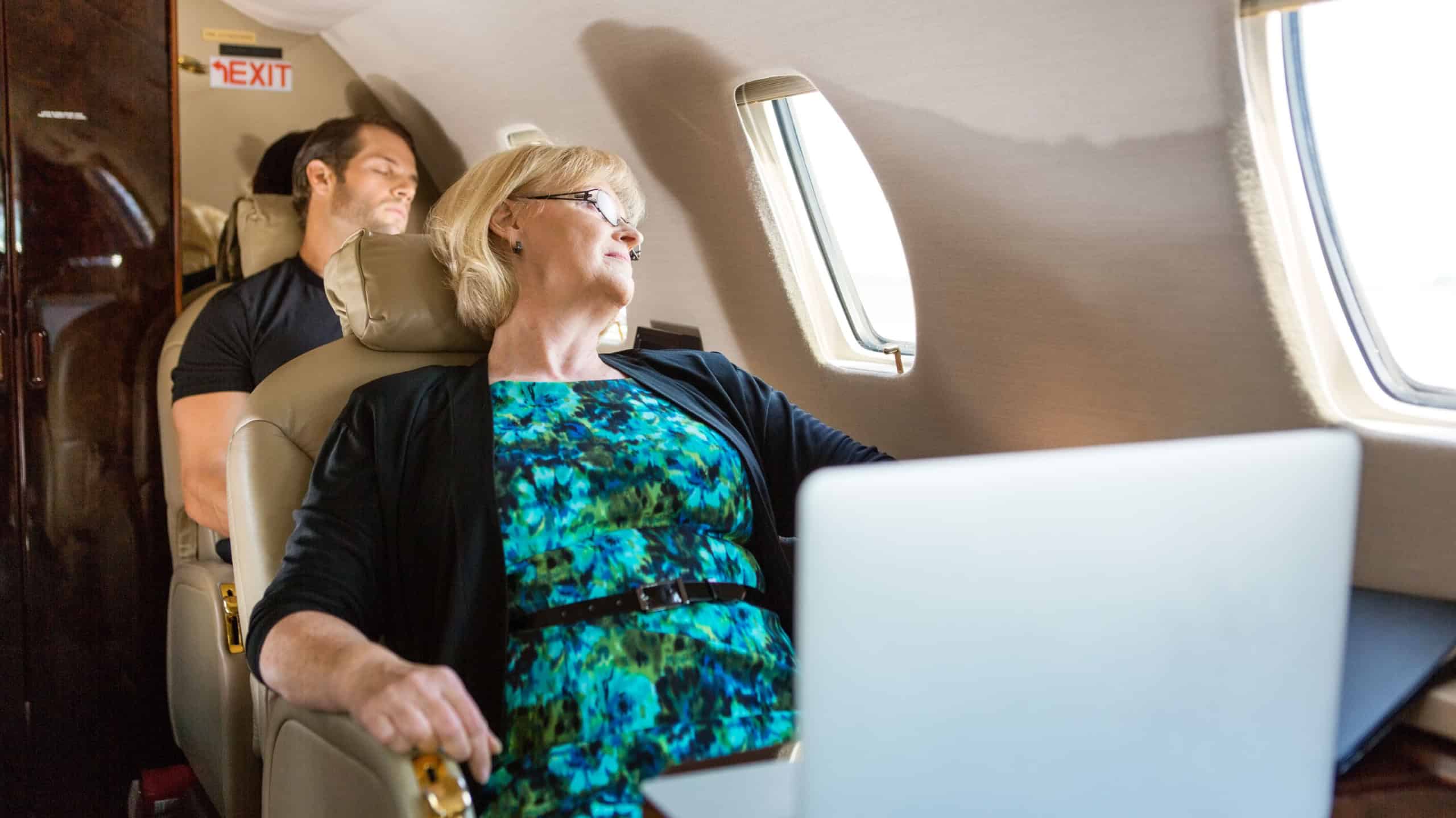Business people sleeping on private plane