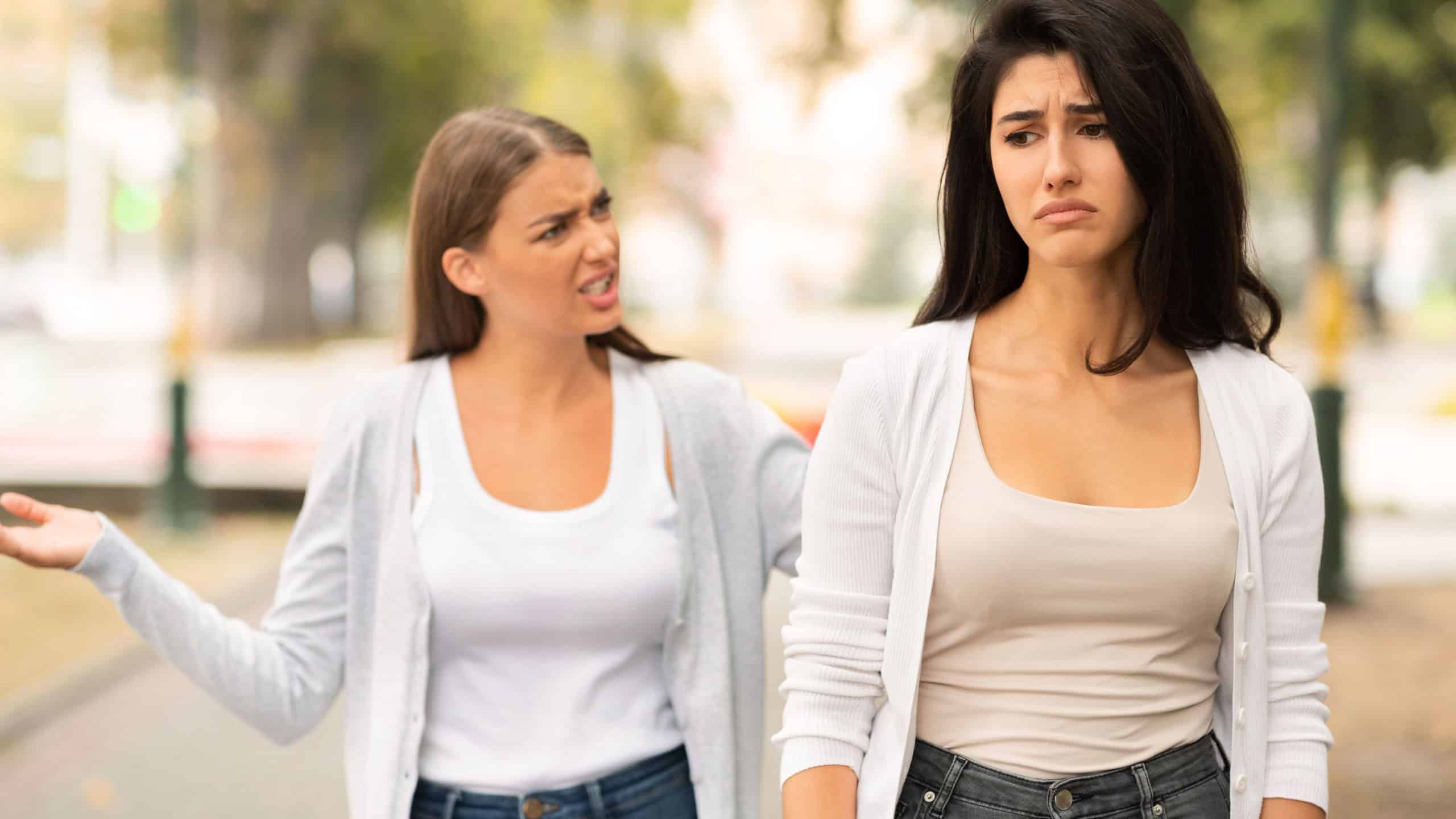 End Of Friendship. Two Girls Friends Having Quarrel Walking In Park Outdoors.