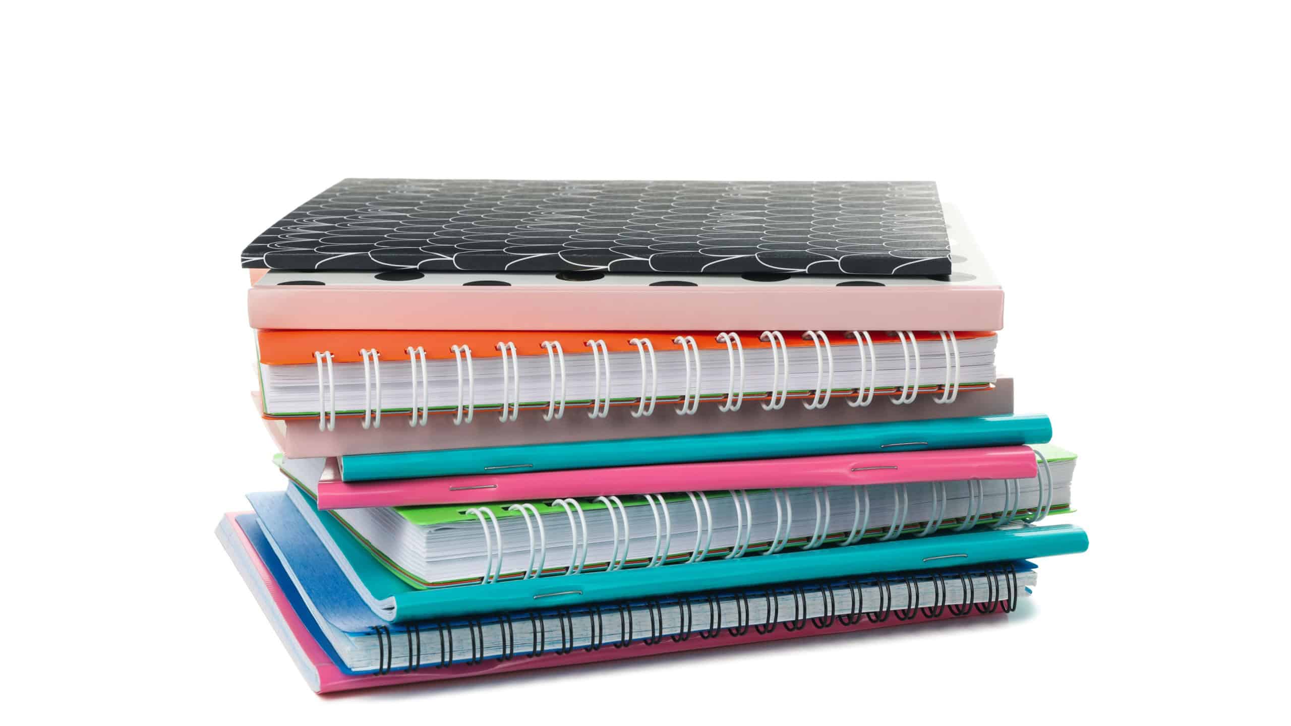 Pile of different notebooks isolated on white background