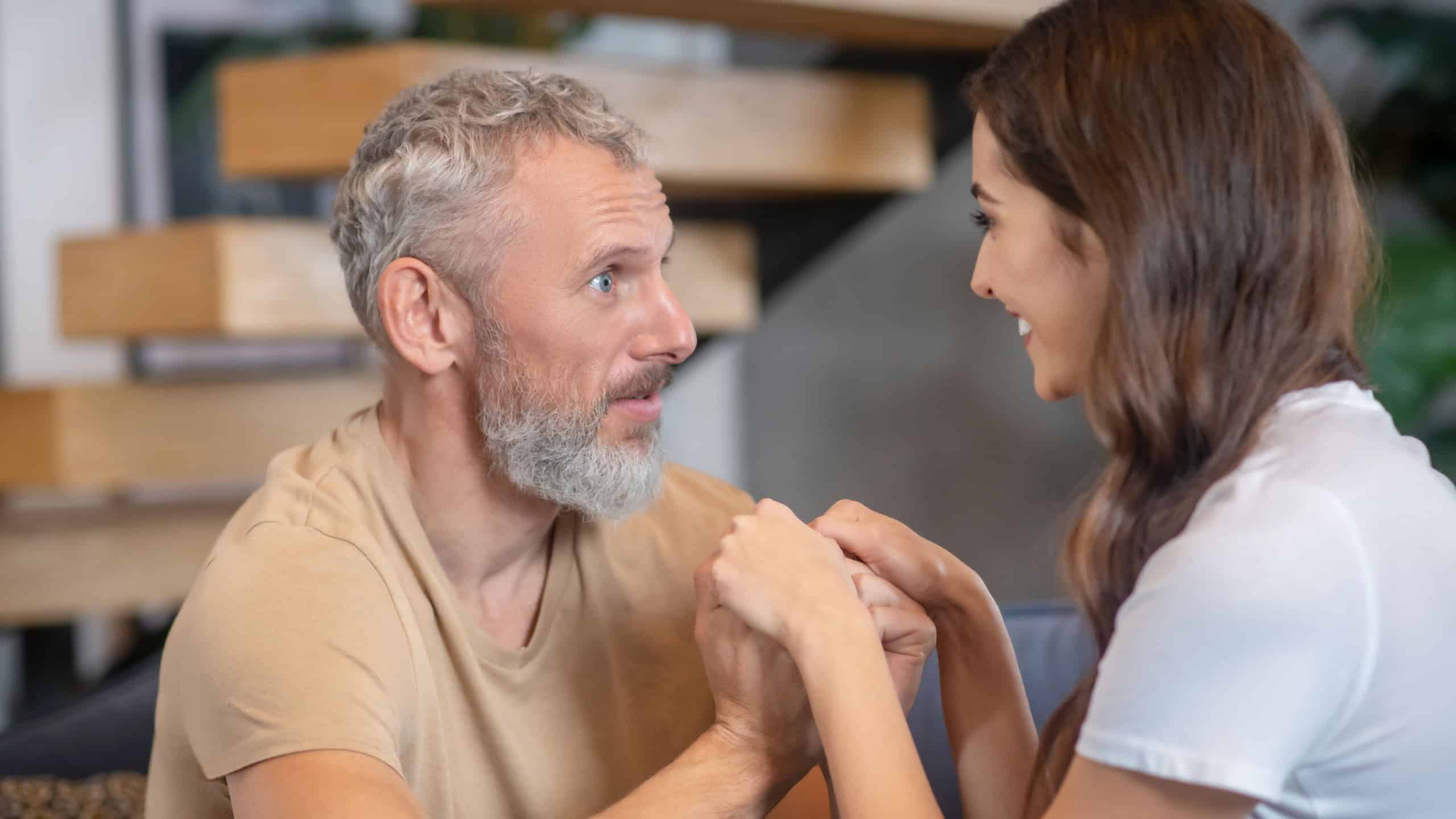 A bearded man and young woman enjoying being together