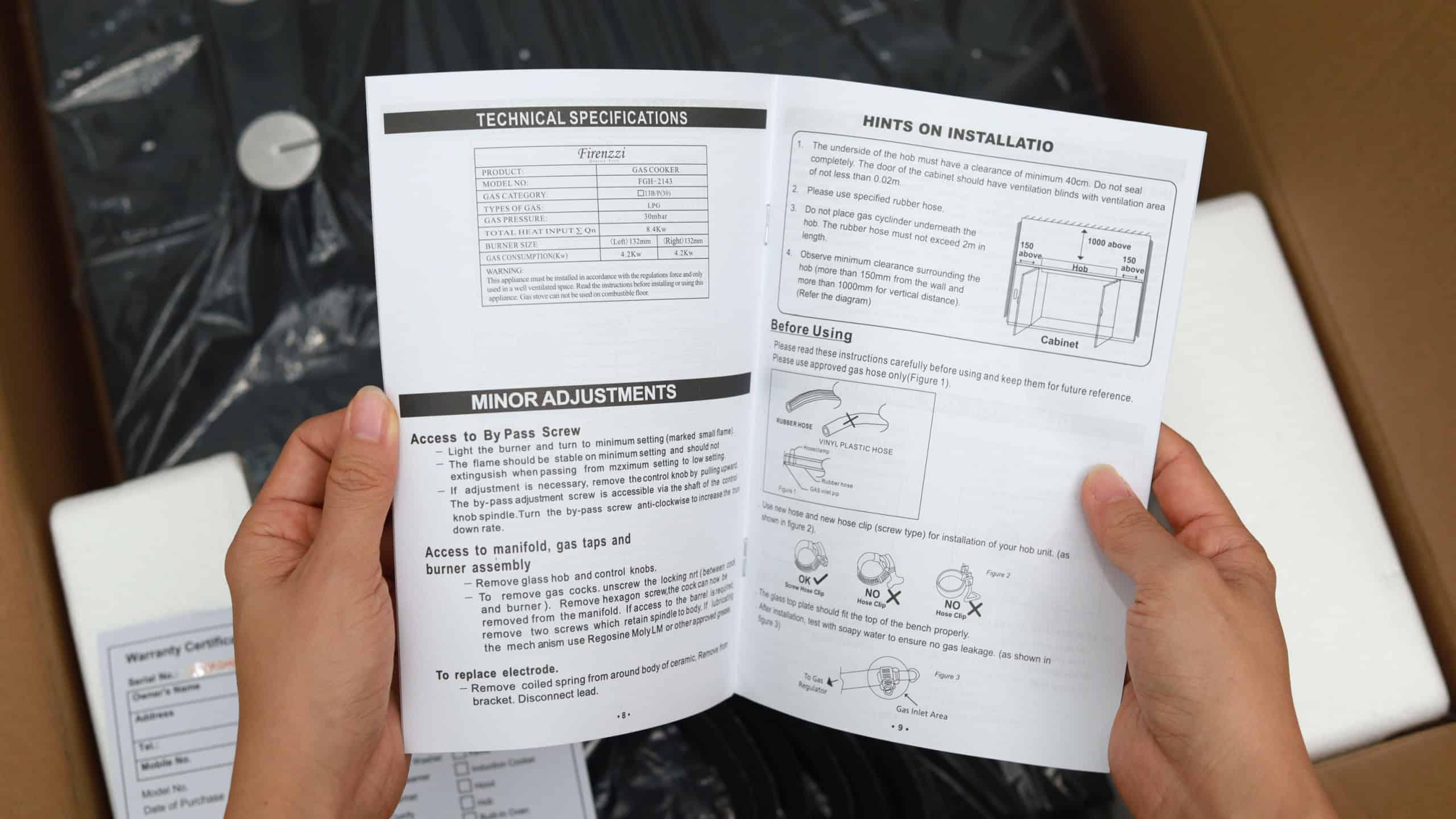 Penang, Malaysia - 5 Feb 2021: Close up a man reading a user manual of the new cooking stove during the open box.