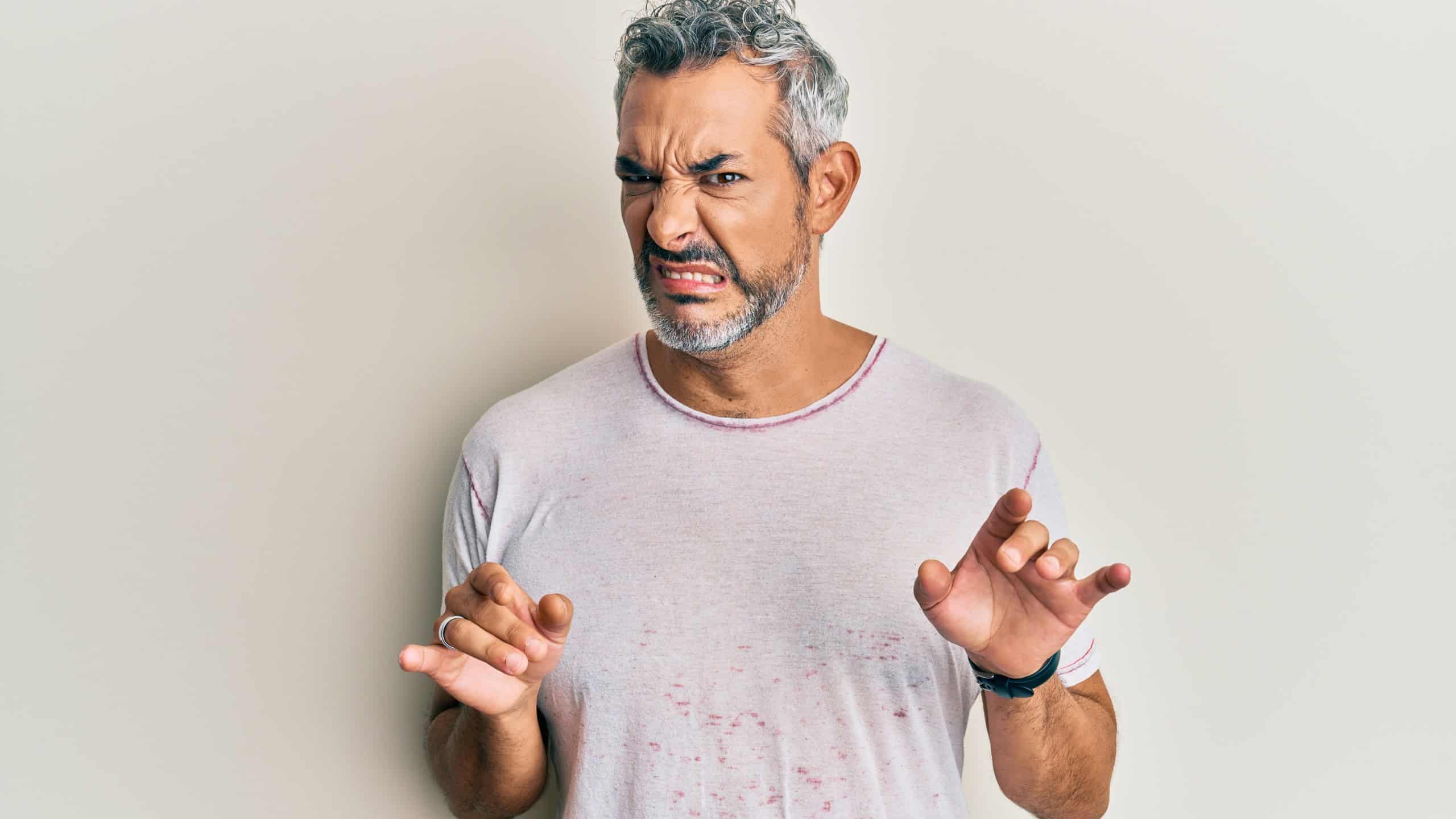 Middle age grey-haired man wearing casual clothes disgusted expression, displeased and fearful doing disgust face because aversion reaction. with hands raised