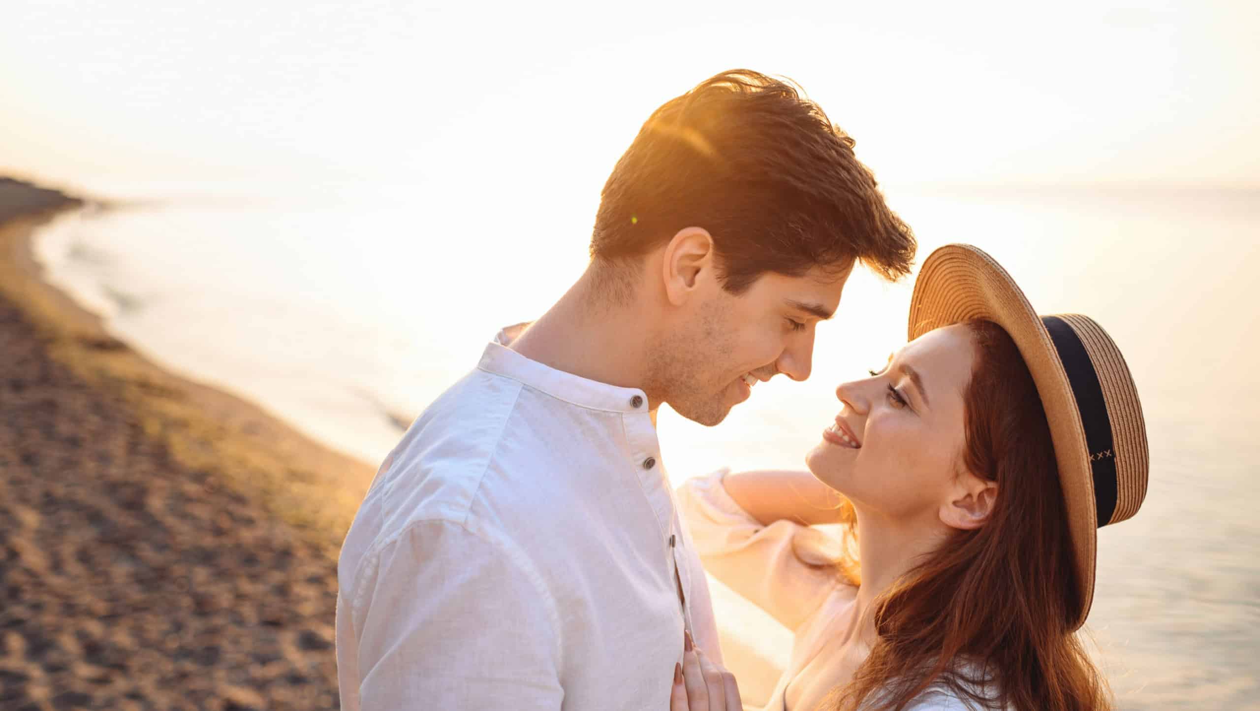 Close up profile young happy tender couple two friends family man woman in white clothes hug going to kiss together at sunrise over sea beach ocean outdoor exotic seaside in summer day sunset evening