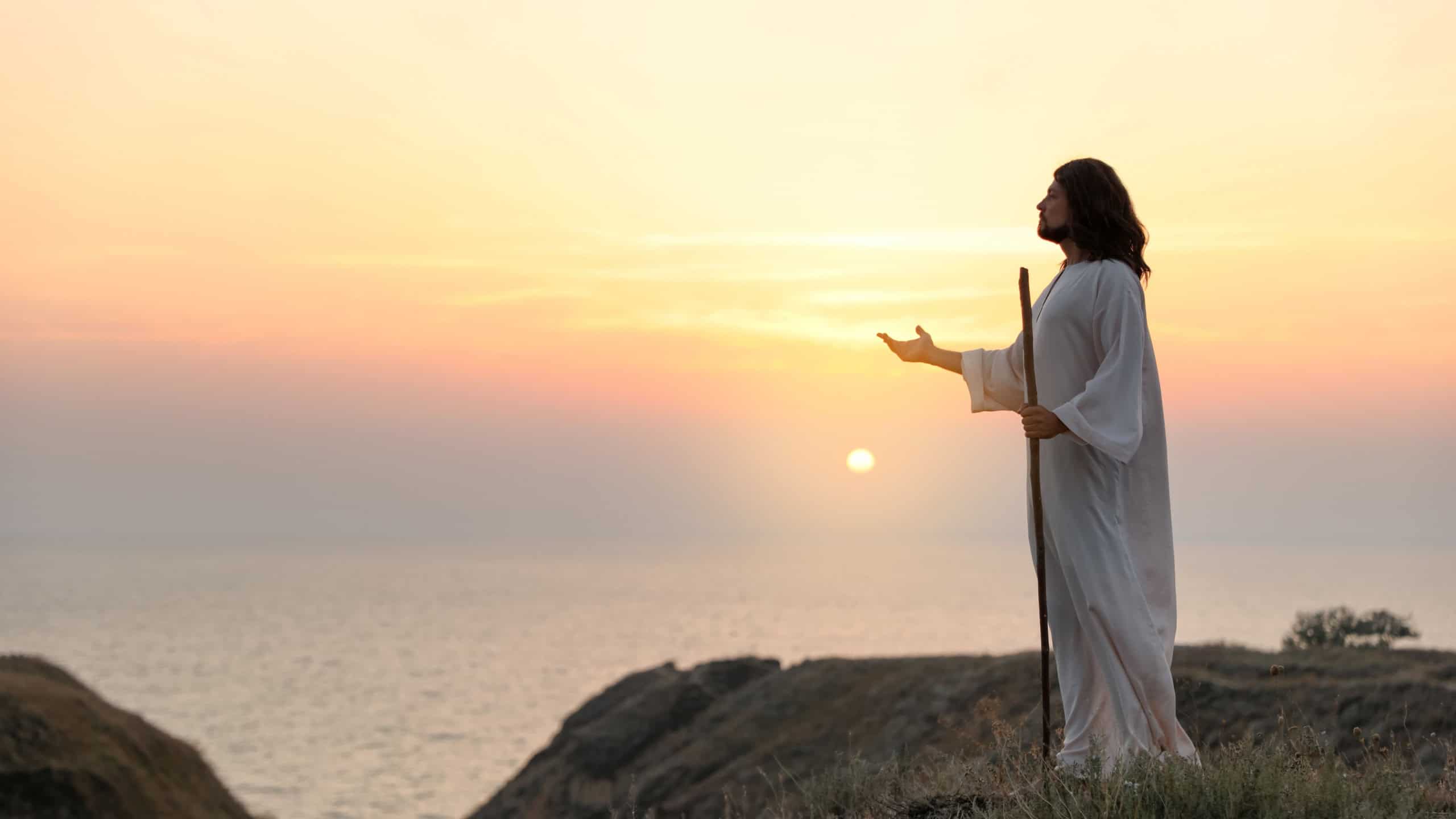 Jesus Christ on hills at sunset.