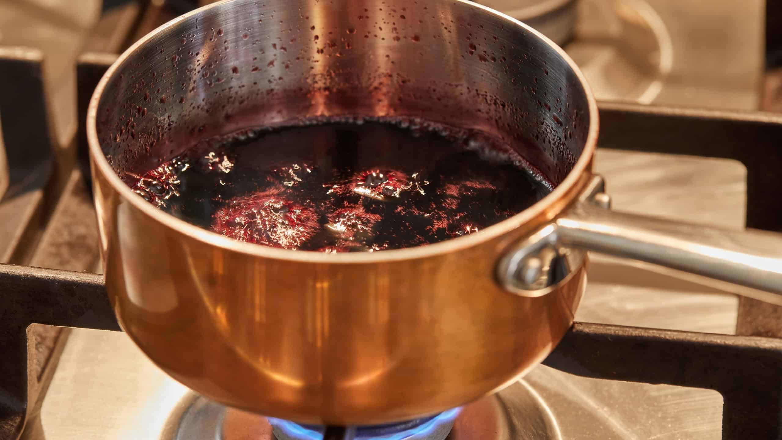 Copper saucepan over low heat on stove to make sauce.