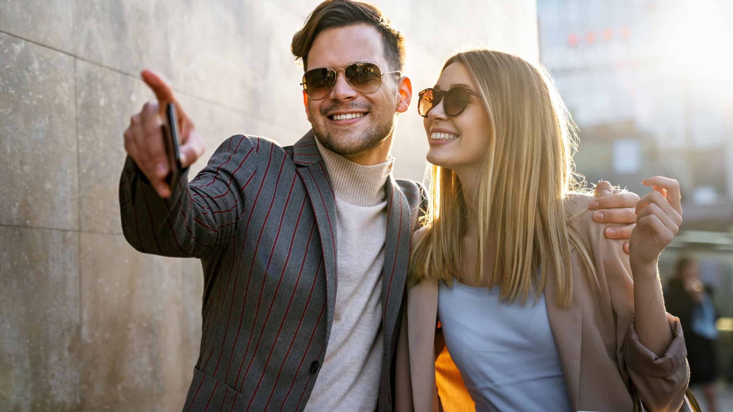 Young successful happy couple having fun in the city together. People date travel business concept.