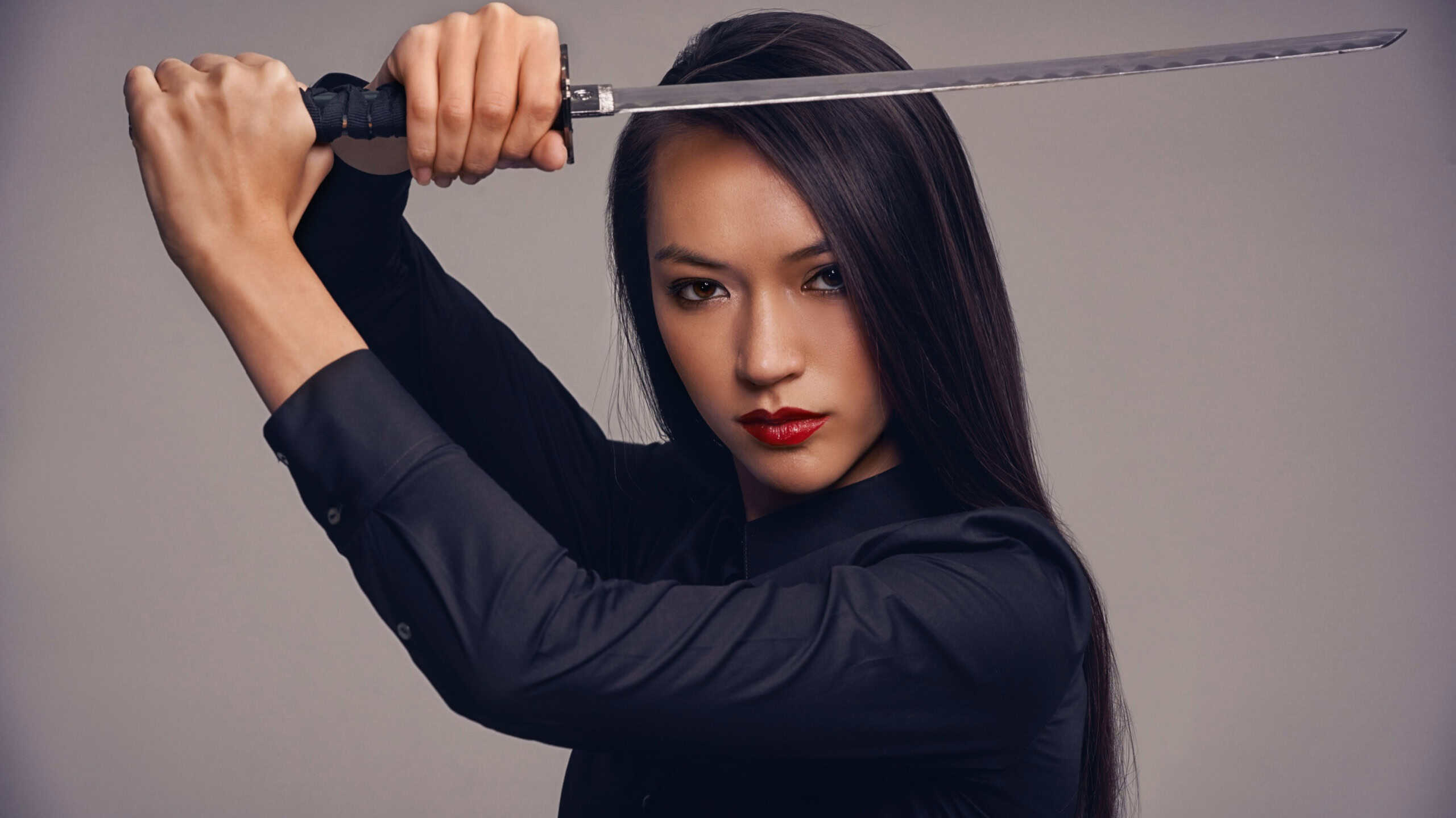 The way of the ninja. Studio portrait of a beautiful young woman in a martial arts outfit wielding a samurai sword.