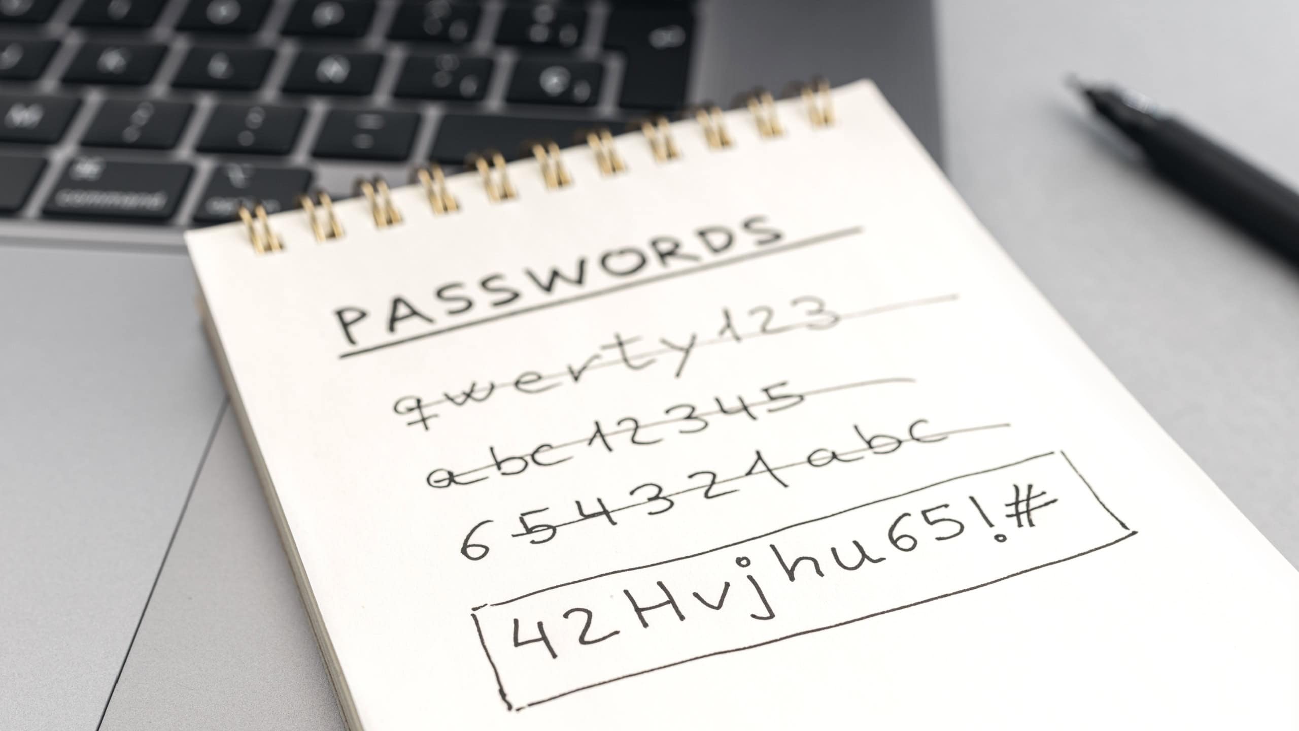 Strong computer security password concept Changing a weak easy Password for a strong one Handwritten text on notepad on laptop