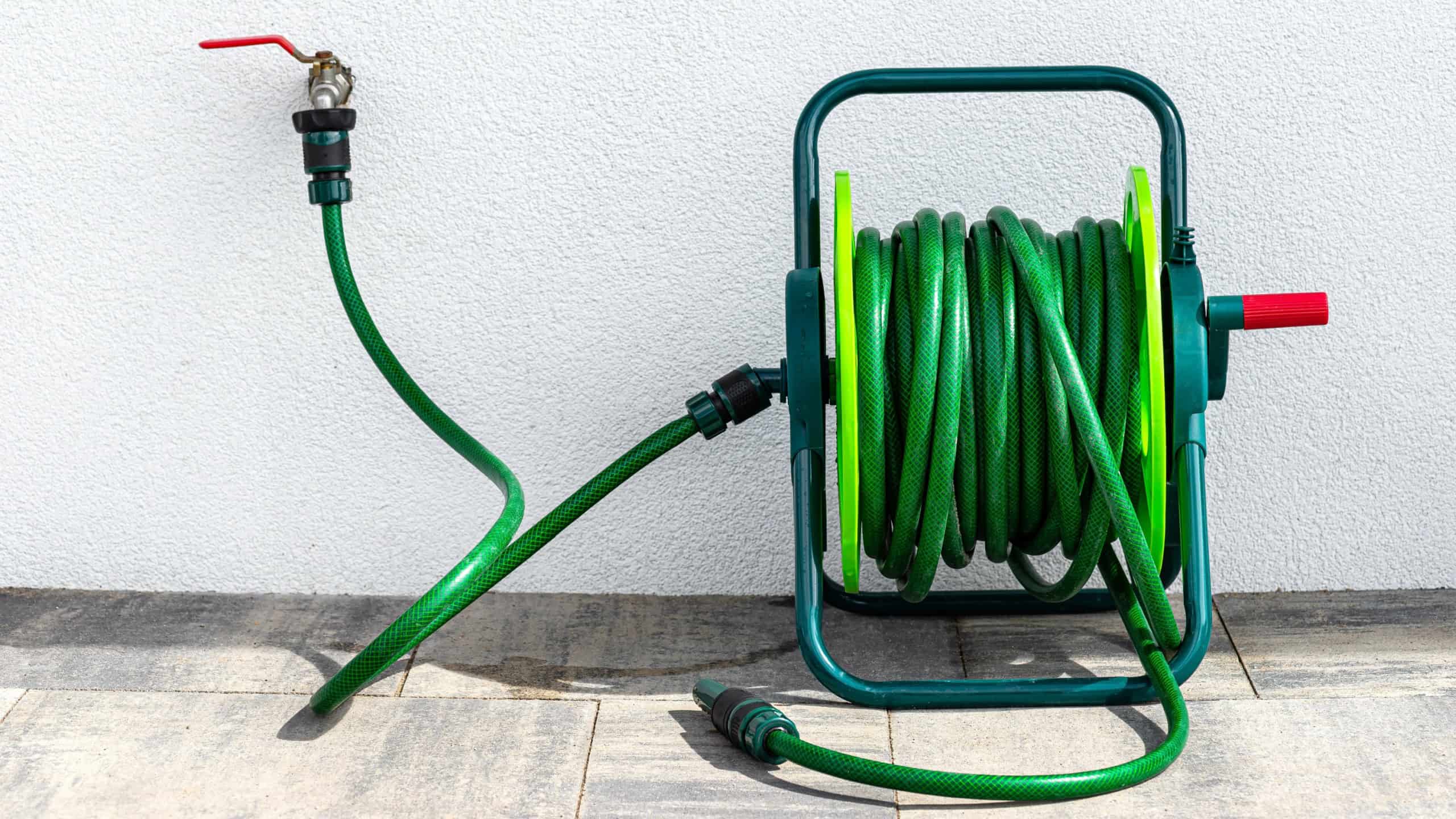 Modern two-story house with large windows and a landscaped front yard, illuminated at night with a clear blue sky.