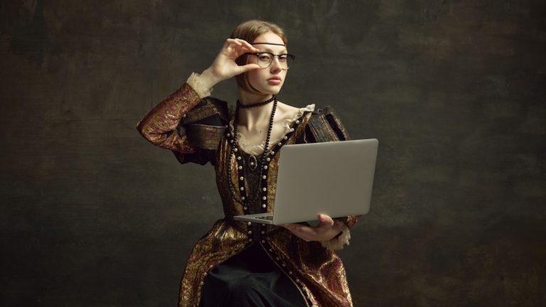 Portrait of young girl, royal person, princess in vintage dress and modern glasses working on laptop against dark green background. Concept of history, renaissance art remake, comparison of eras