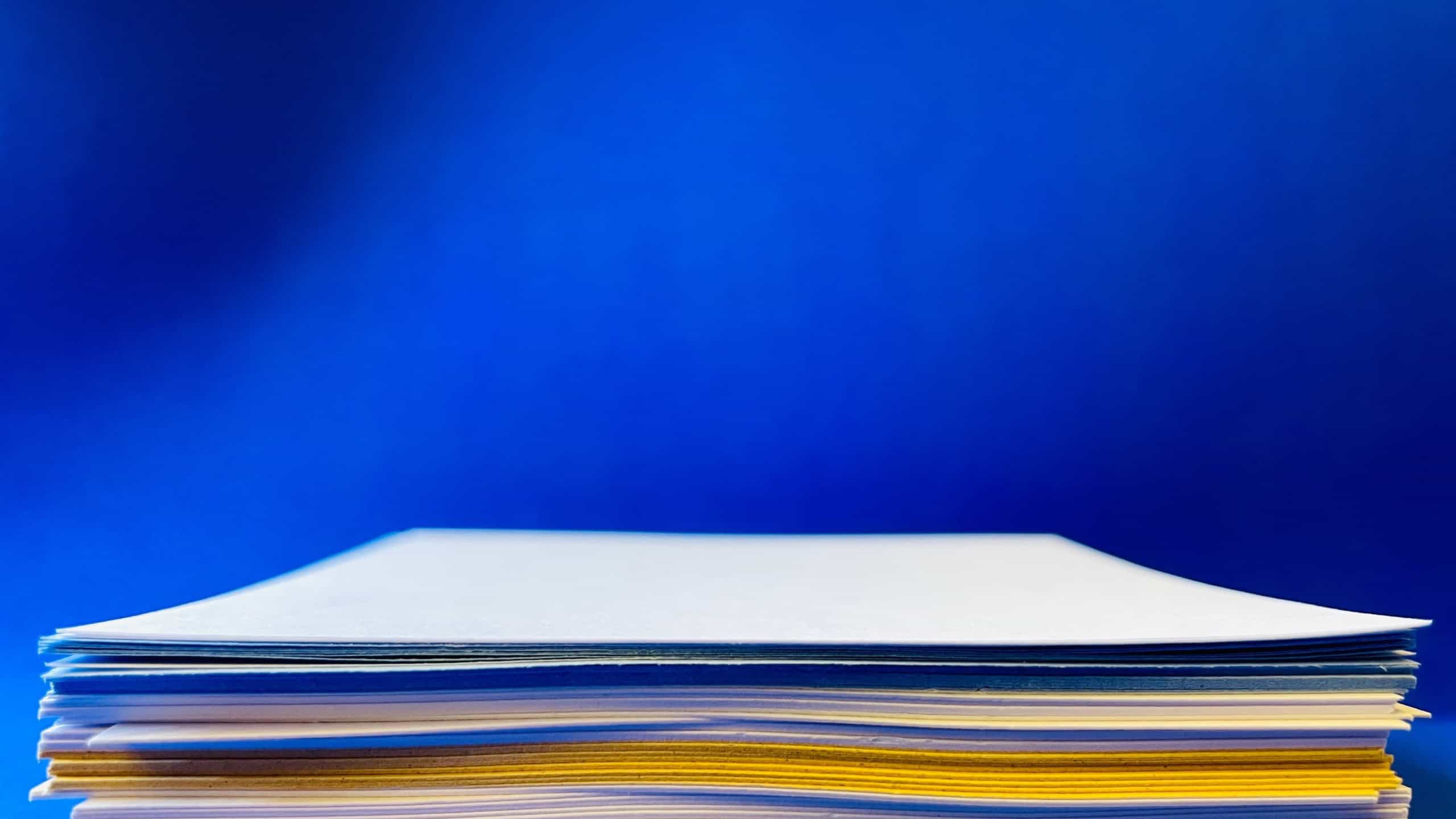 Sheets of paper. Stack of paper. Blank sheet. Background paper. Blue background