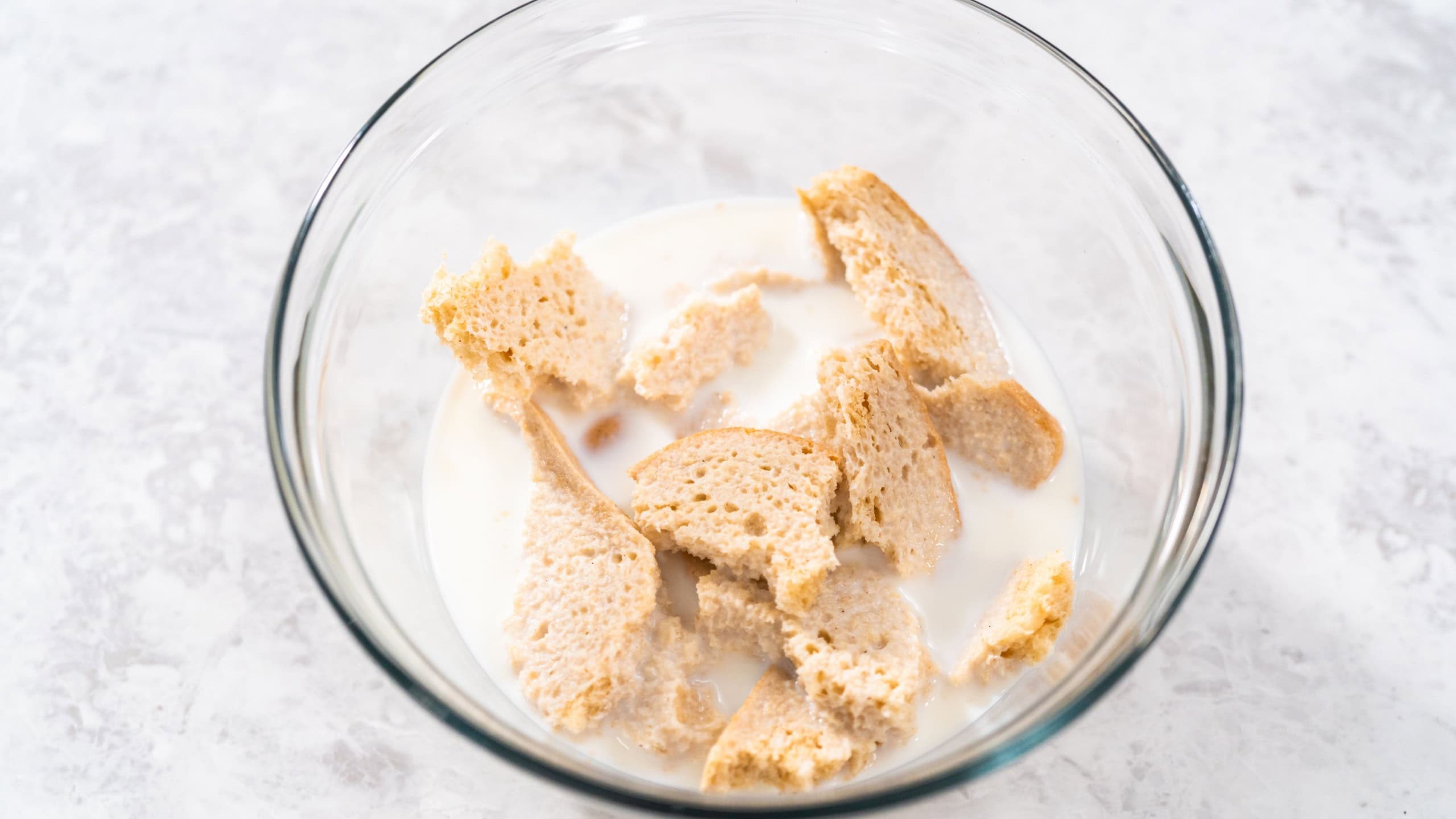 Soaking stale bread in milk to make meatloaf.