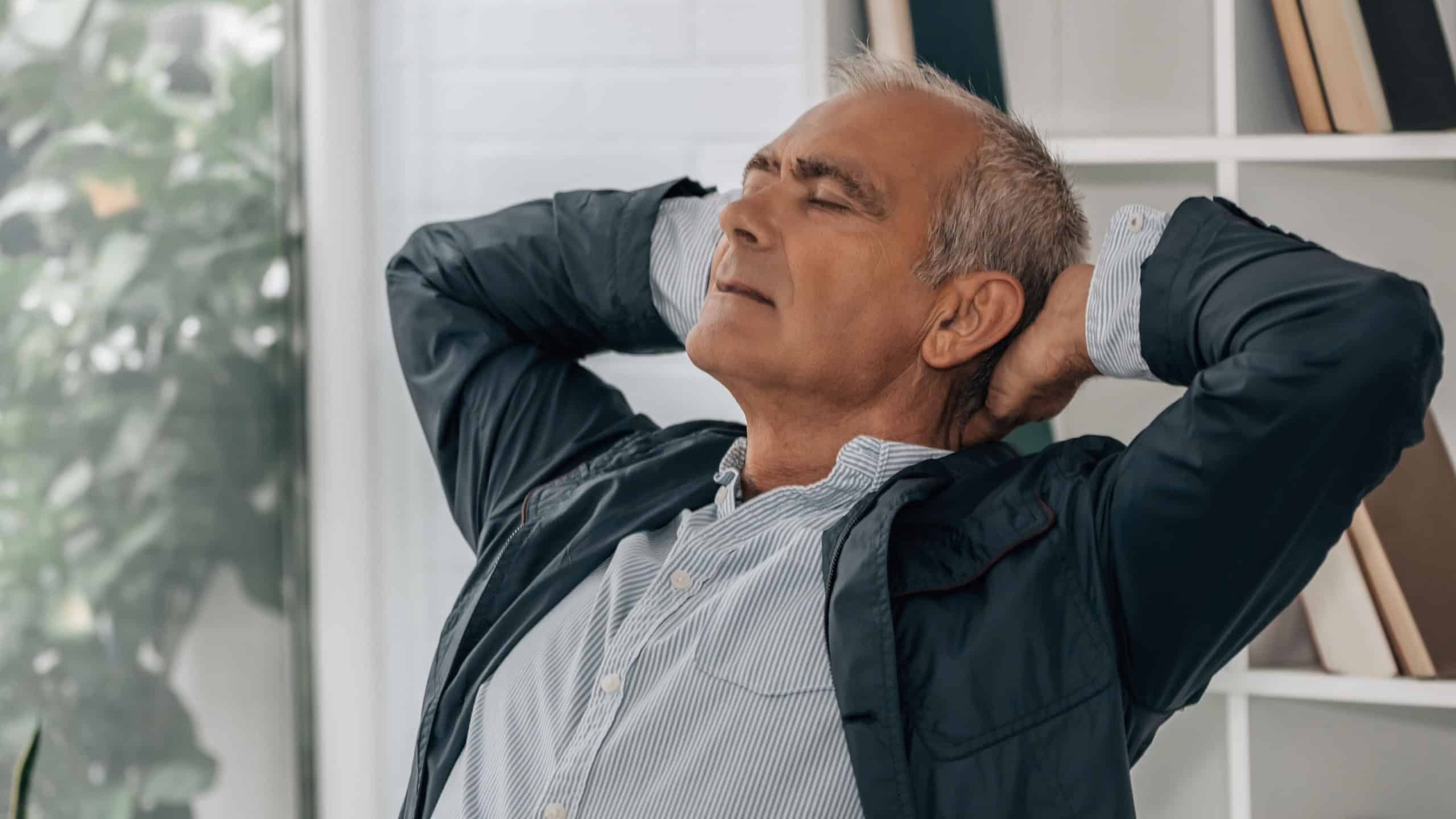 relaxed mature businessman in office or workplace