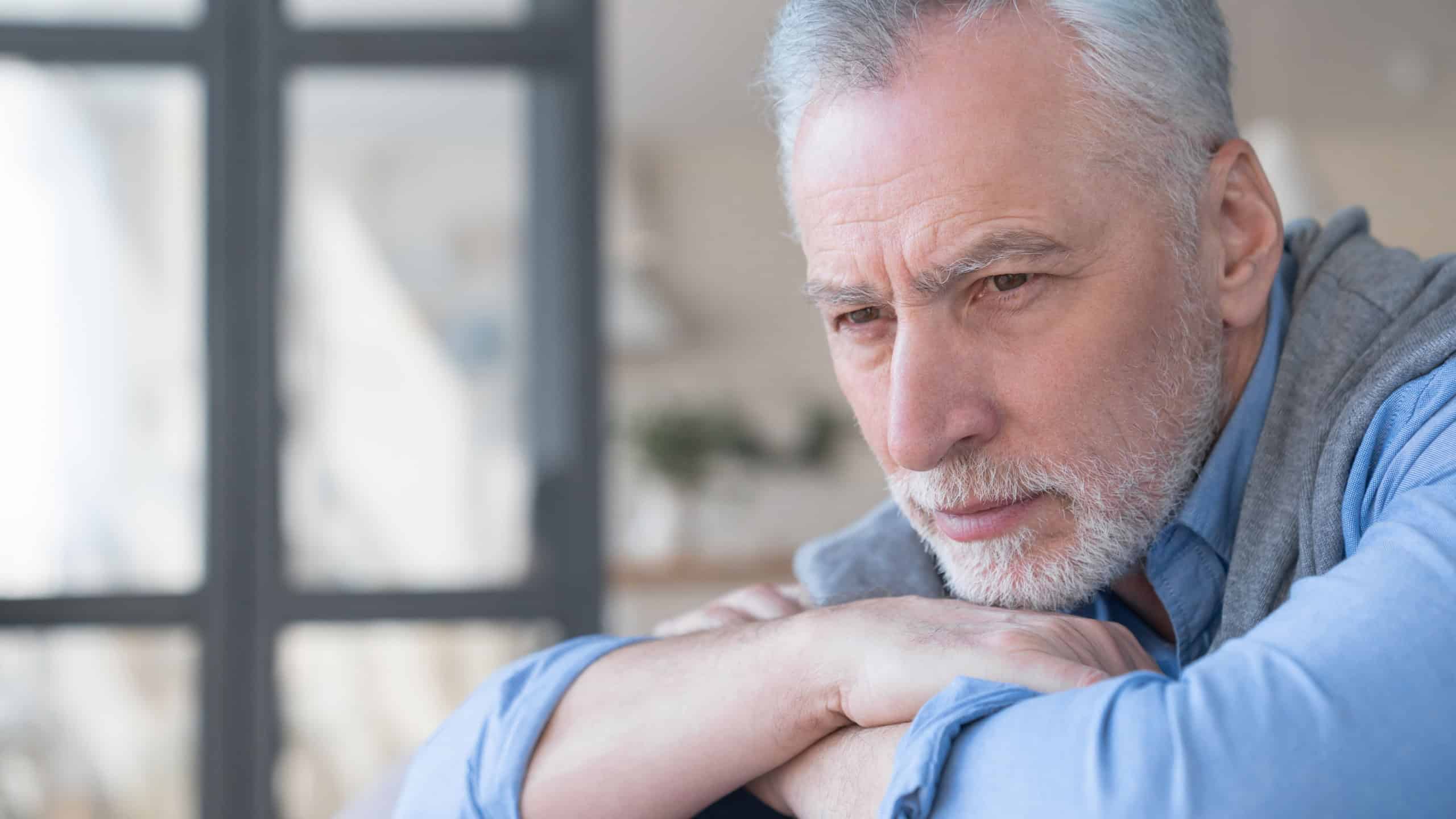 Close up image of a sad pensive lonely caucasian old elderly senior man grandfather having problem, the lack of family communication, loneliness. Old man left alone at home, no visitors.