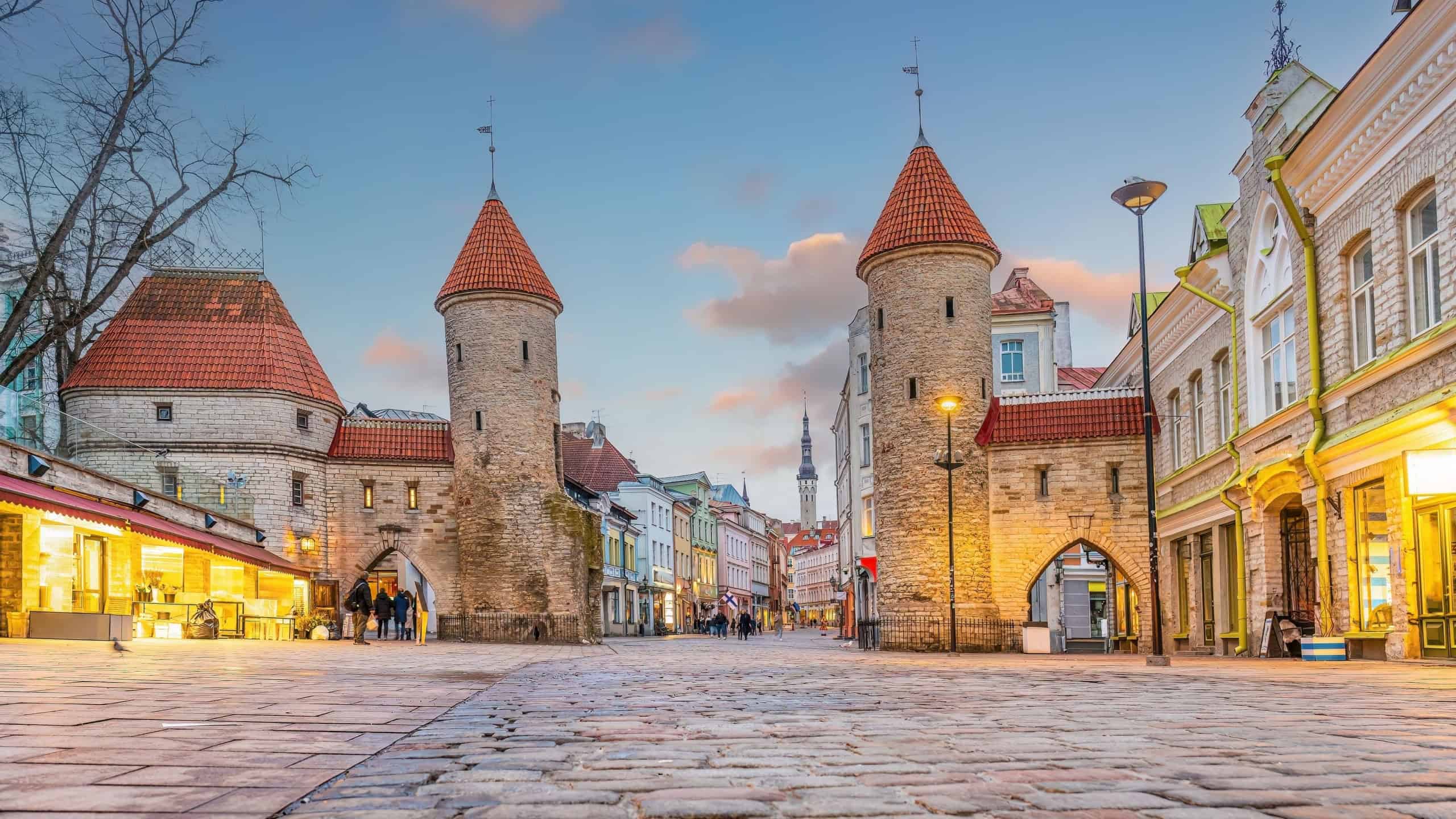 Twin towers of Viru Gate in Old town Tallinn, cityscape of Estonia at sunset