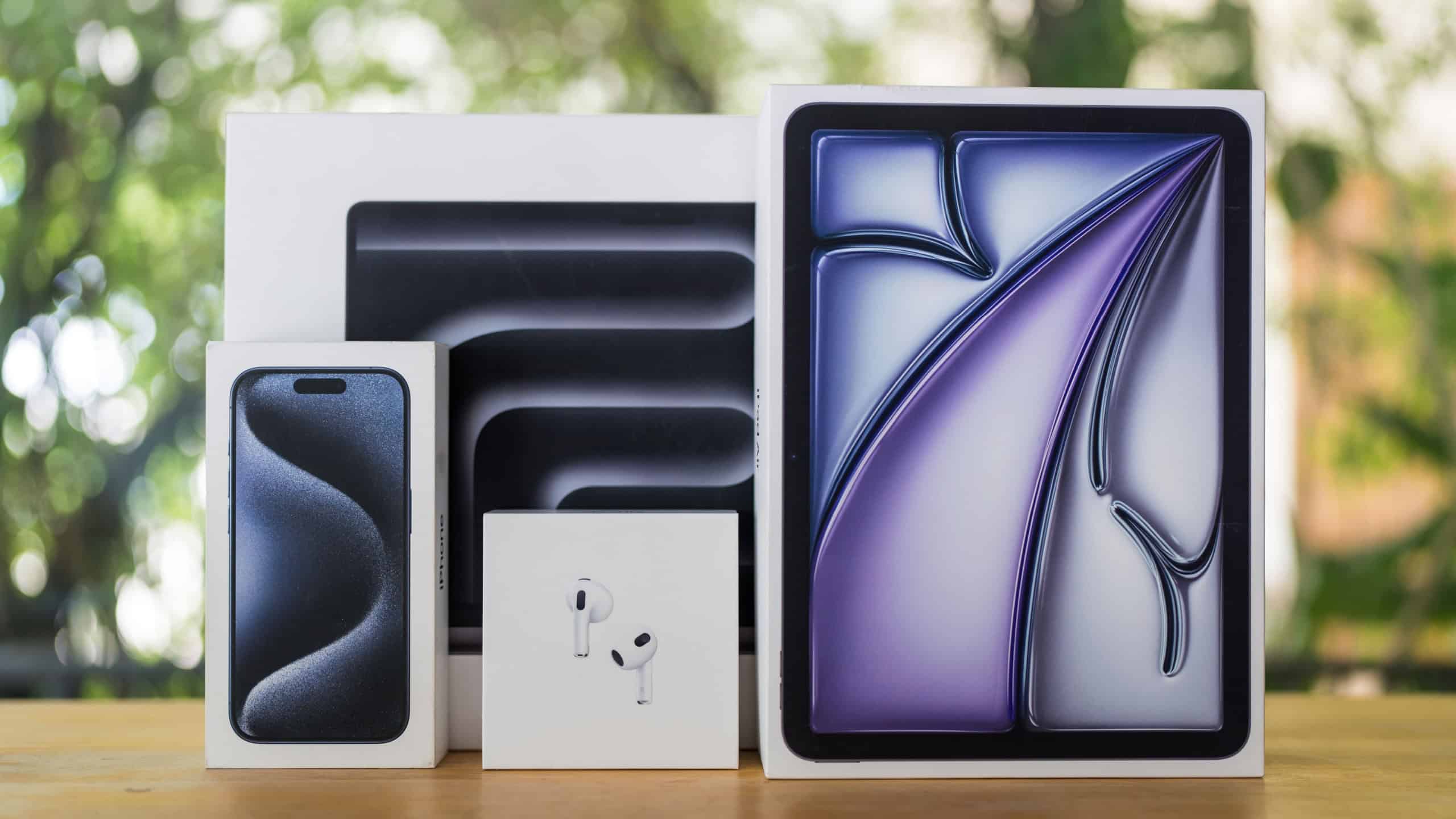 Bangkok, Thailand - September 16, 2024 : Boxes from Apple devices include AirPods, iPhone, iPad Air and Macbook Pro against nature background. The concept of Apple company devices.