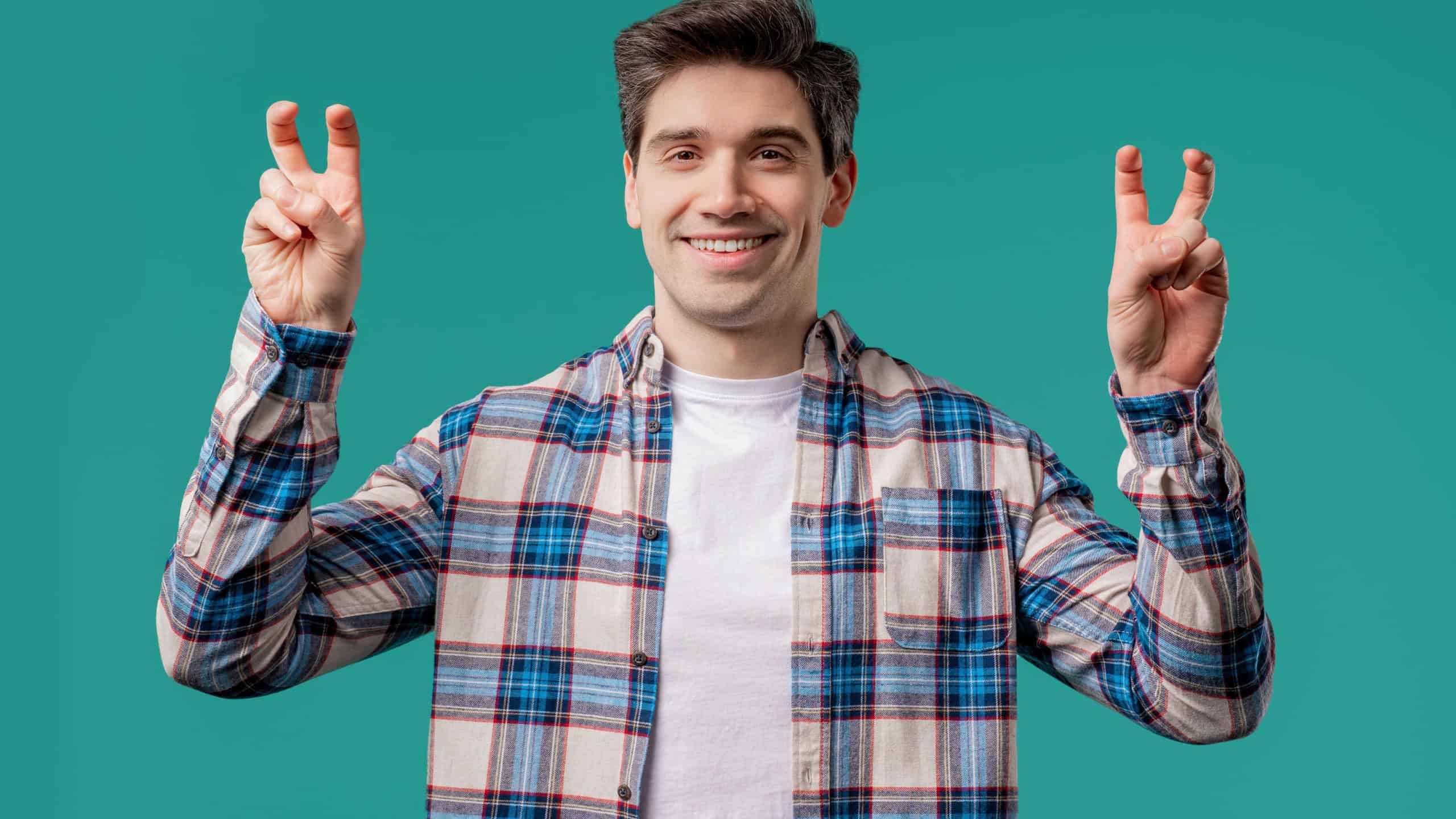 Handsome 30s man with hands two fingers air quotes gesture on blue, sarcasm. High quality