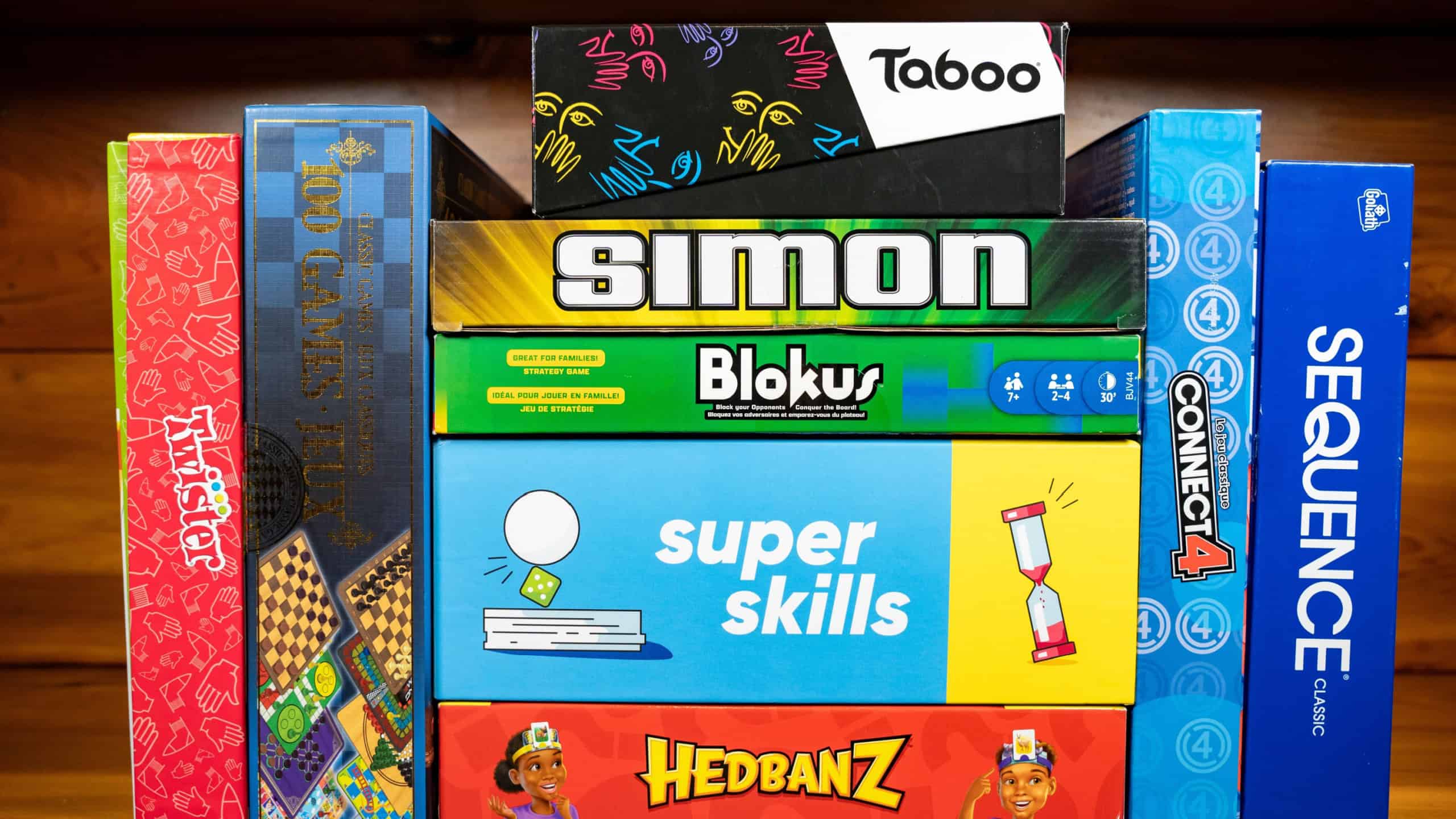 Boxes of board games. Connect 4, Twister, 100 Games, Simon, Blokus, Sequence, Super Skills, Hedbanz and Taboo board games. Toronto, Canada - October 5, 2024.