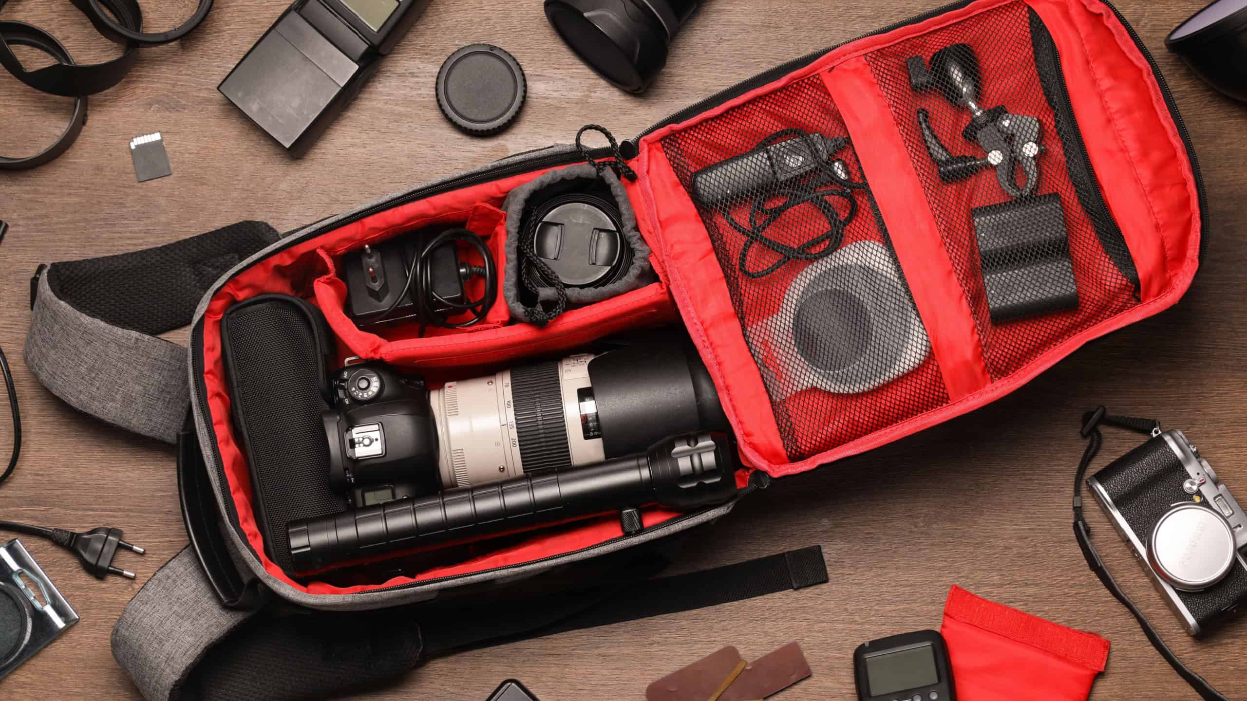 Photographer's equipment on wooden background, flat lay