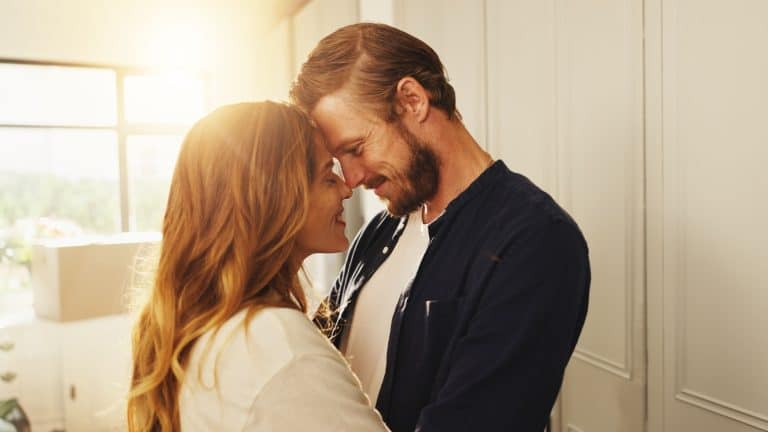 Home, forehead and couple with love, smile or bonding together with happiness, romance or trust. Apartment, lens flare or man with woman, relationship or marriage with kindness, commitment or support