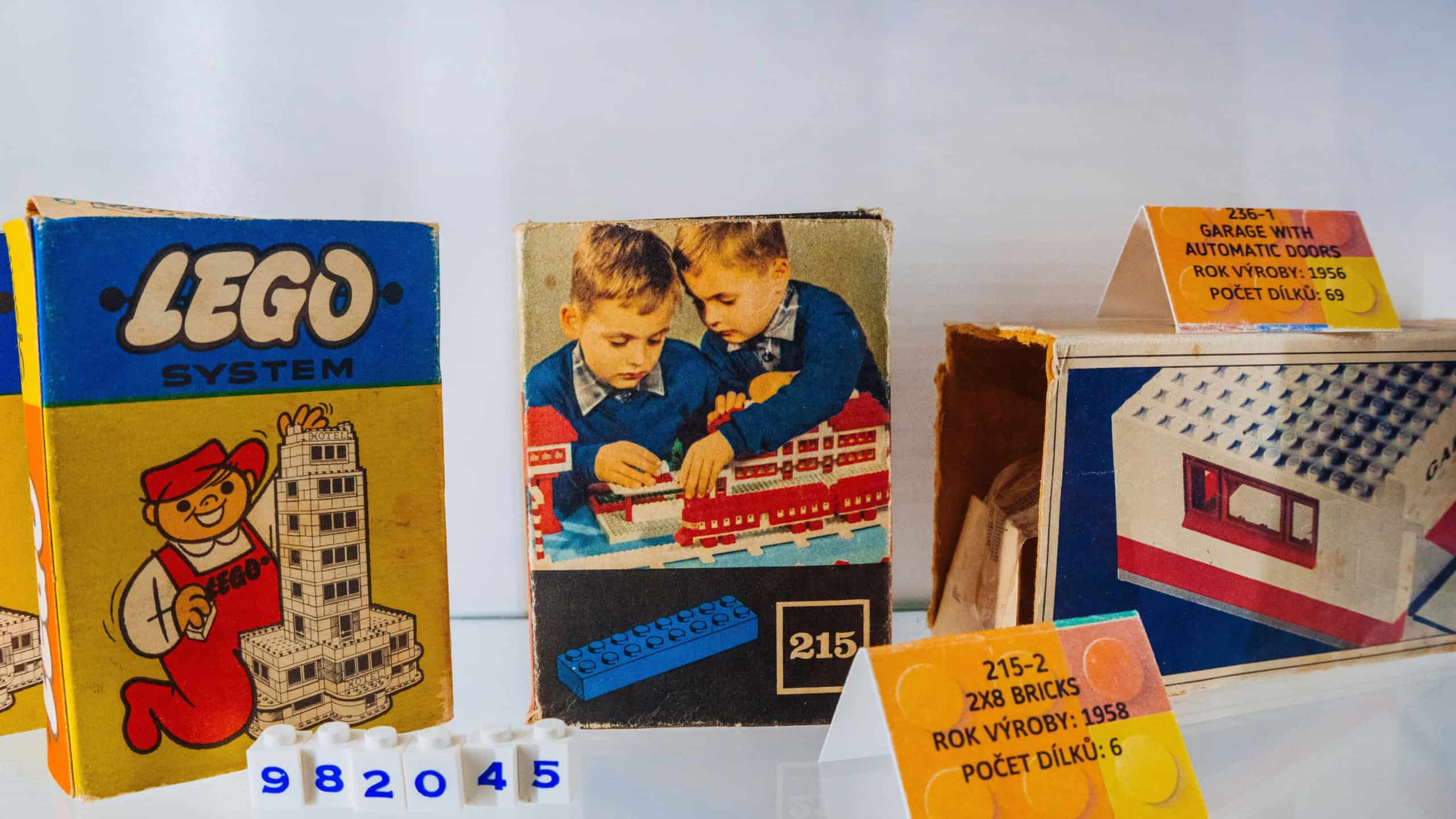 Prague, Czechia - September 20, 2025: Retro LEGO System sets from the 1950s showcased in museum exhibit, featuring classic packaging and early brick designs that highlight the brands history.