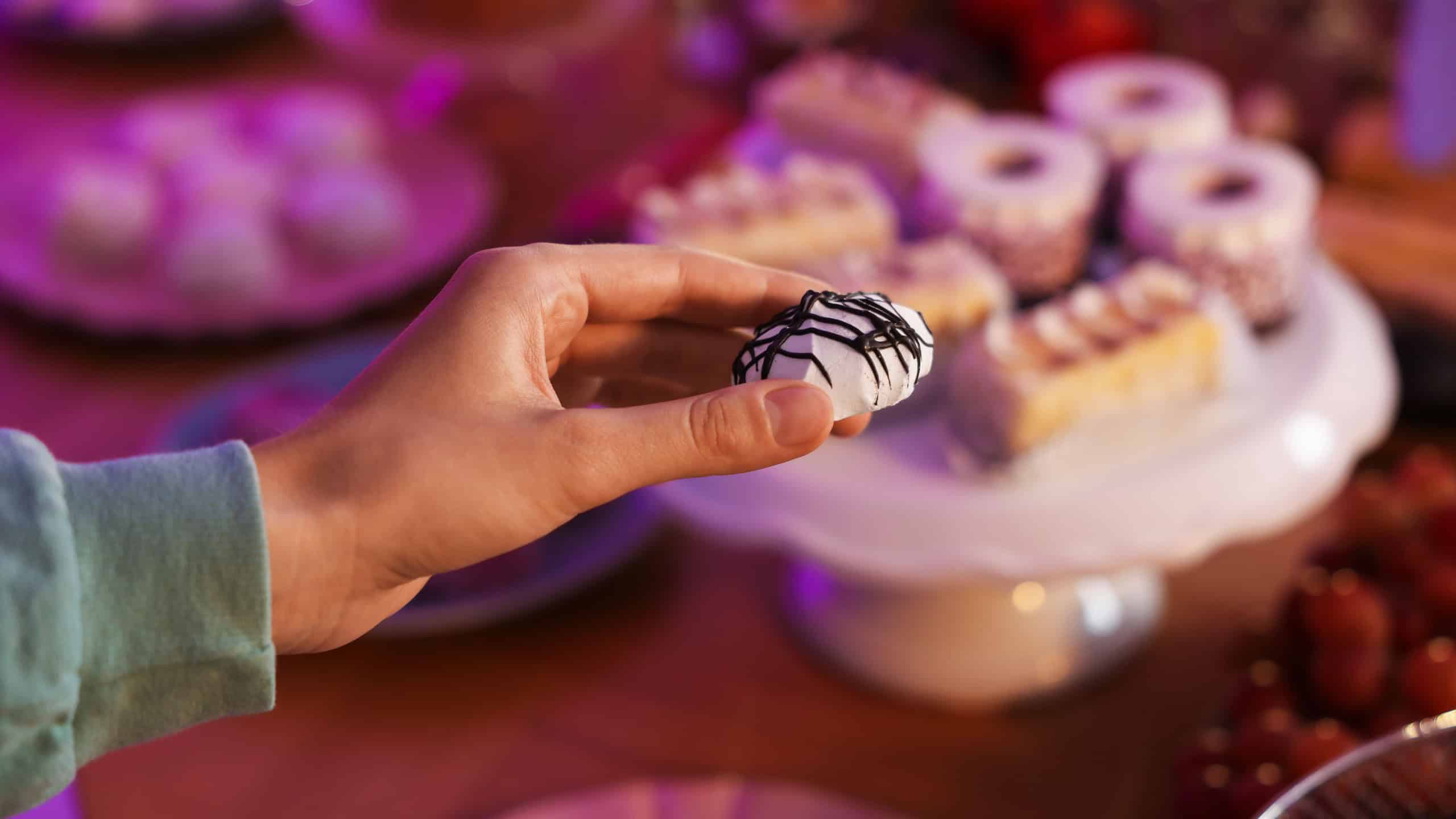 Guest taking delicious dessert from buffet table, closeup