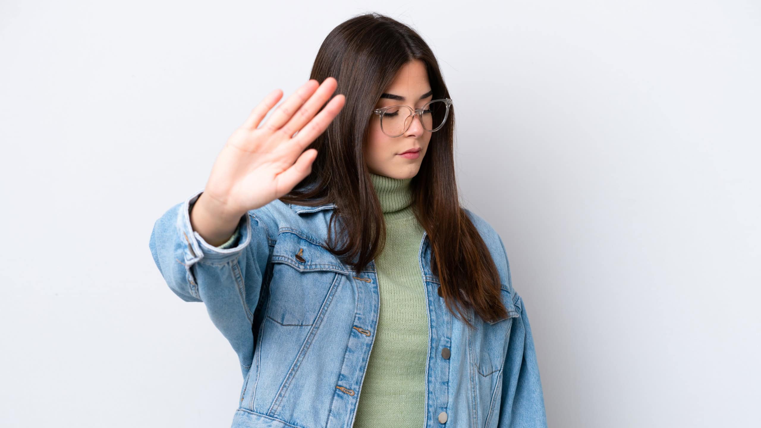 Young Brazilian woman isolated on white background making stop gesture and disappointed