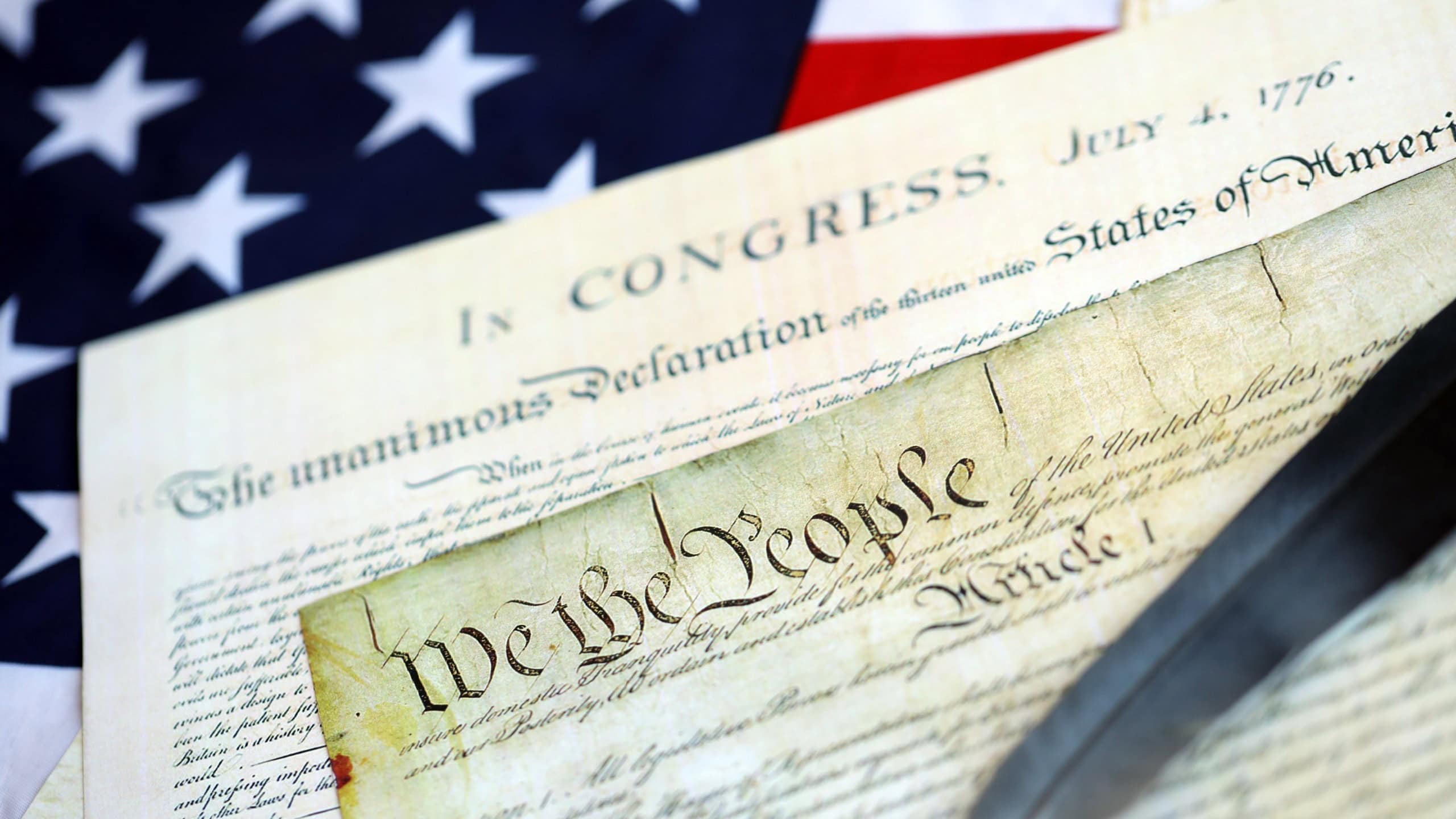 Aged historical documents Washington DC on American Declaration of independence 4th july 1776 on U.S. flag close up