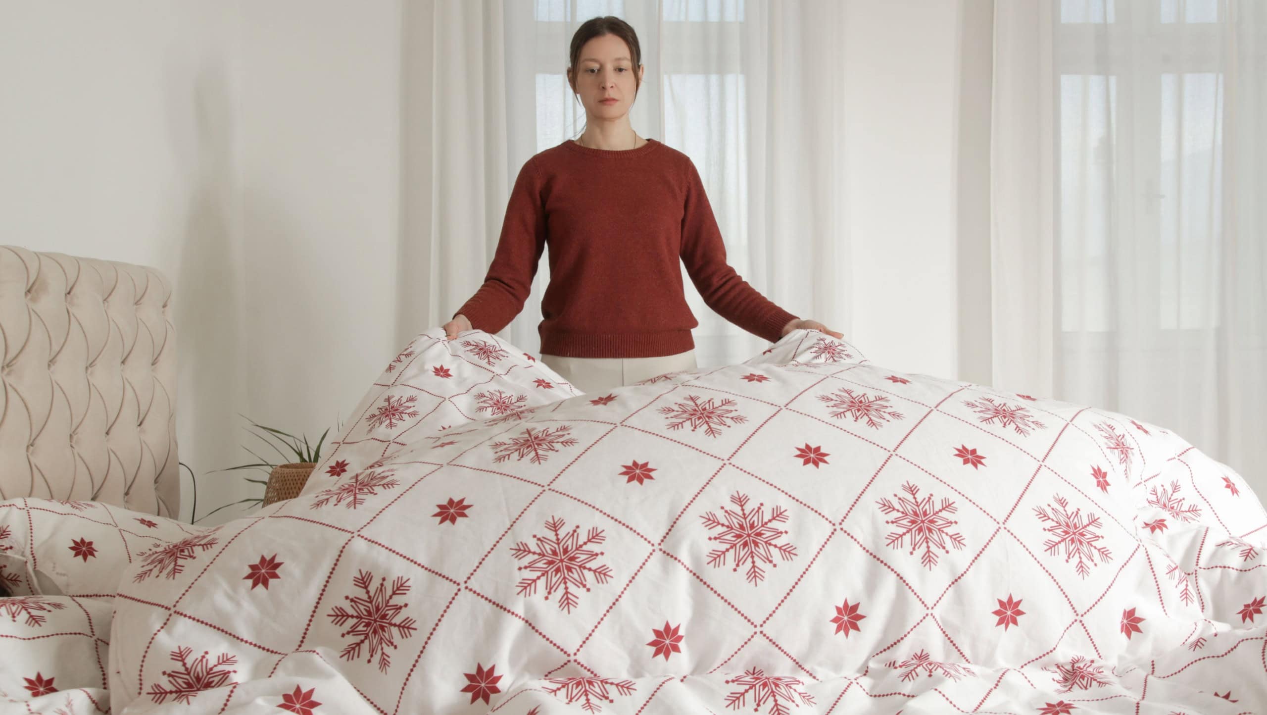 Woman changing bed linens at home in her bedroom, cozy domestic lifestyle, housewife cleaning, tidying up bedroom, housework concept. stock photo