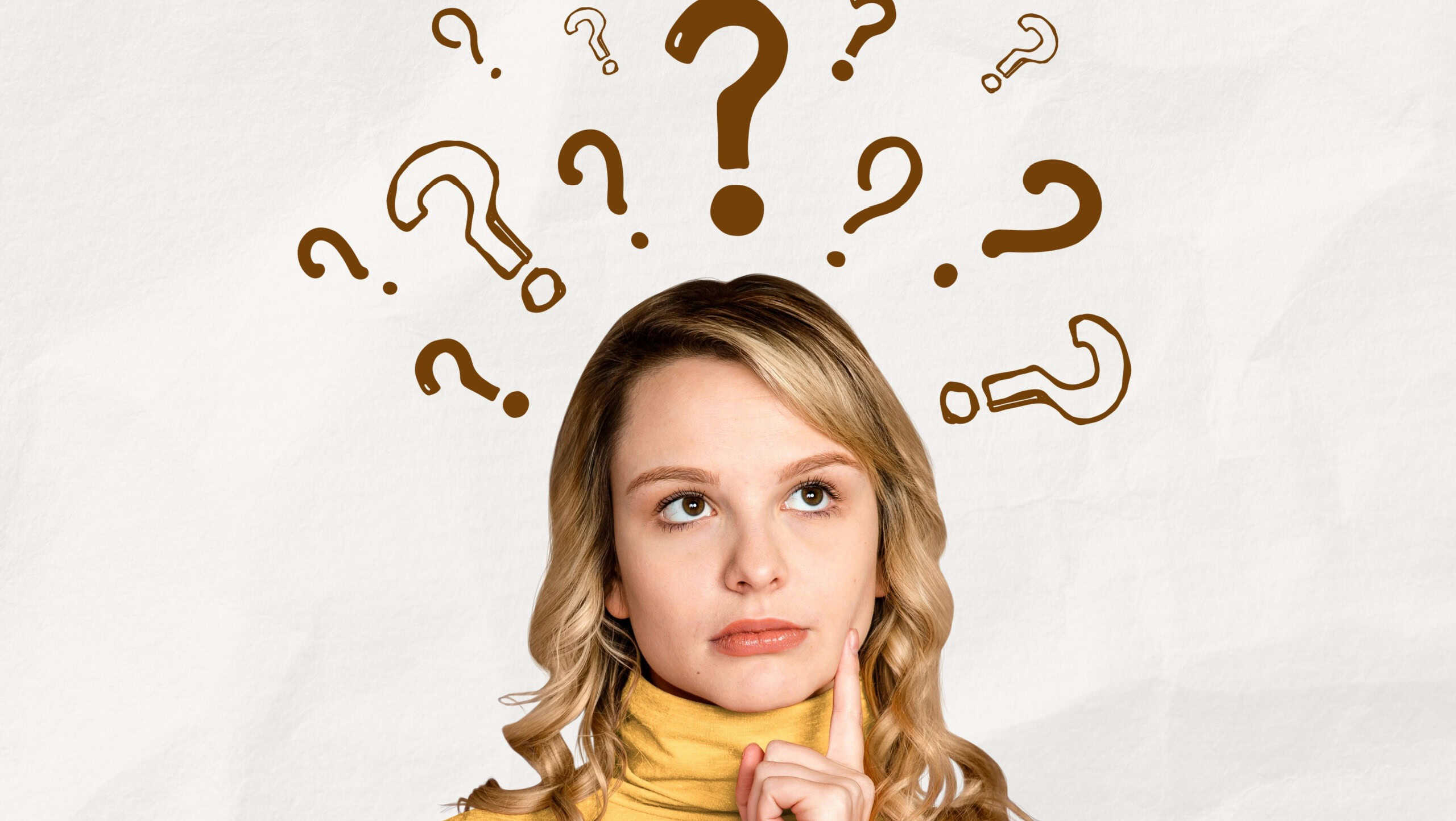 Woman in a yellow sweater pondering with question marks above her head, symbolizing confusion or curiosity.