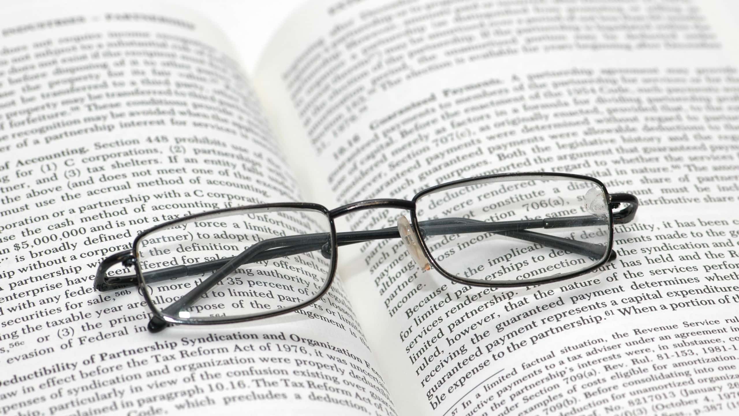 Reading glasses with light frame over the open book