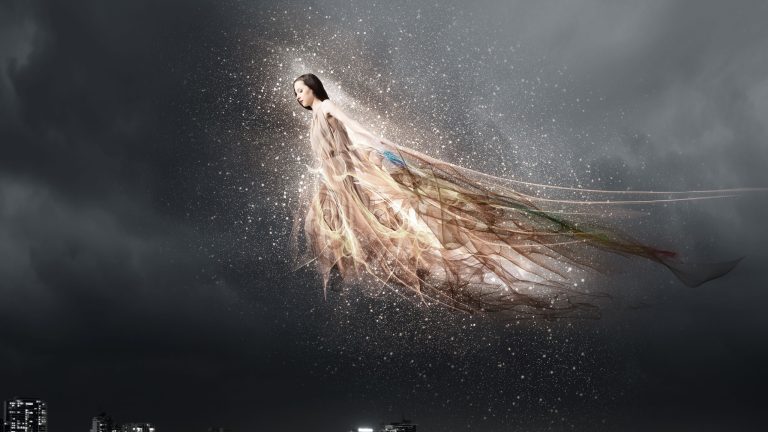 Attractive woman with angel wings on sky background